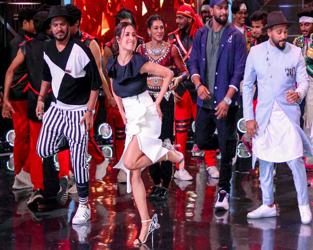Bollywood actress Malaika Arora performs with contestants at the TV set of 'Dance India Dance' show in Mumbai - PTI