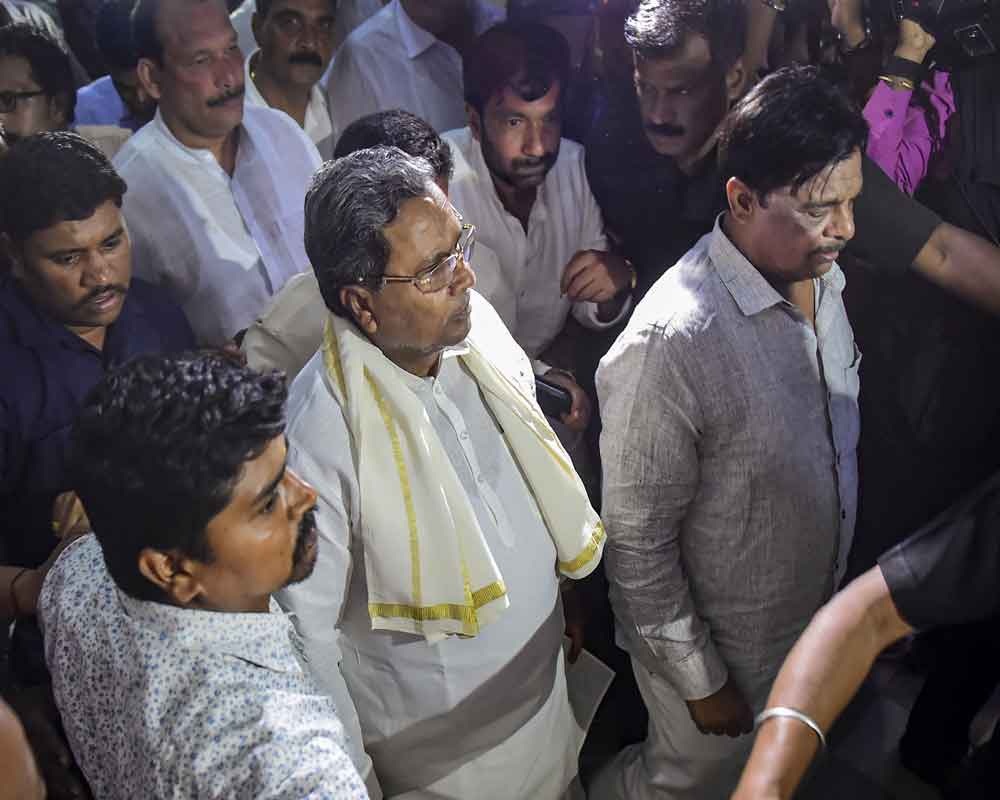 Former Karnataka chief minister Siddaramaiah leaves the chamber of Minister KJ George, where Congress leaders kept the rebel MLA K Sudhakar, in Bengaluru, - PTI