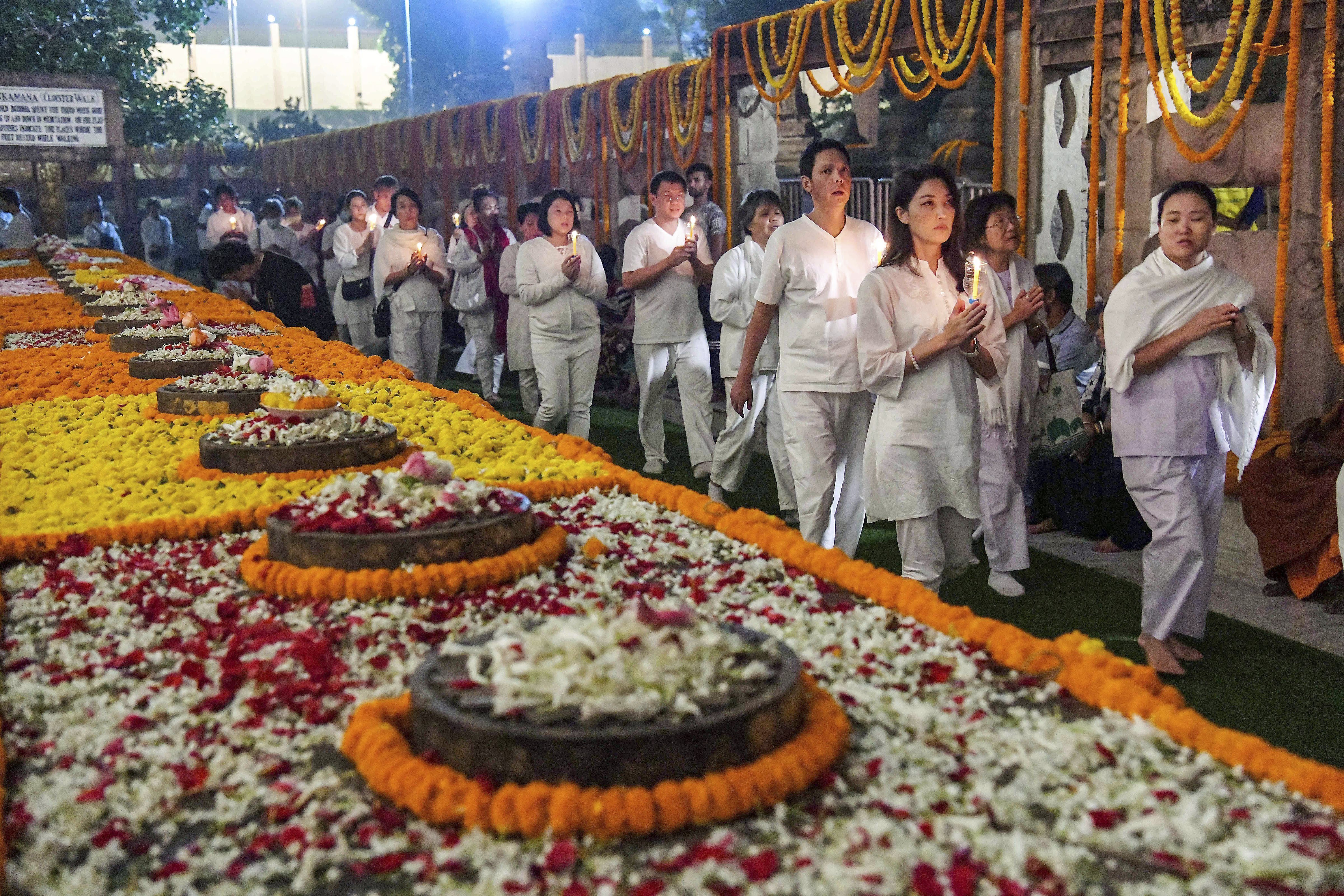 Thai devotees light up candles on the full moon day, at Mahabodhi Temple in Bodhgaya - PTI