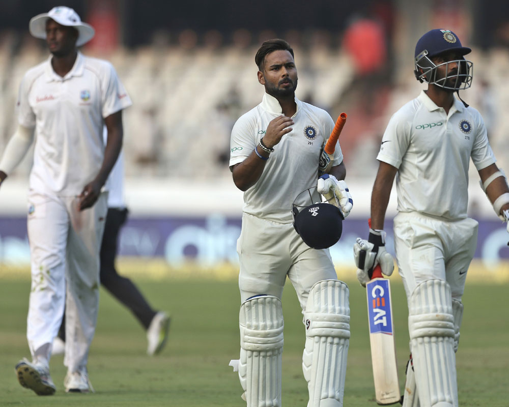 Indian cricketer Rishabh Pant and Ajinkya Rahane, right, walk off the field at the end of the second day of the second cricket test match between India and West Indies in Hyderabad, India - AP