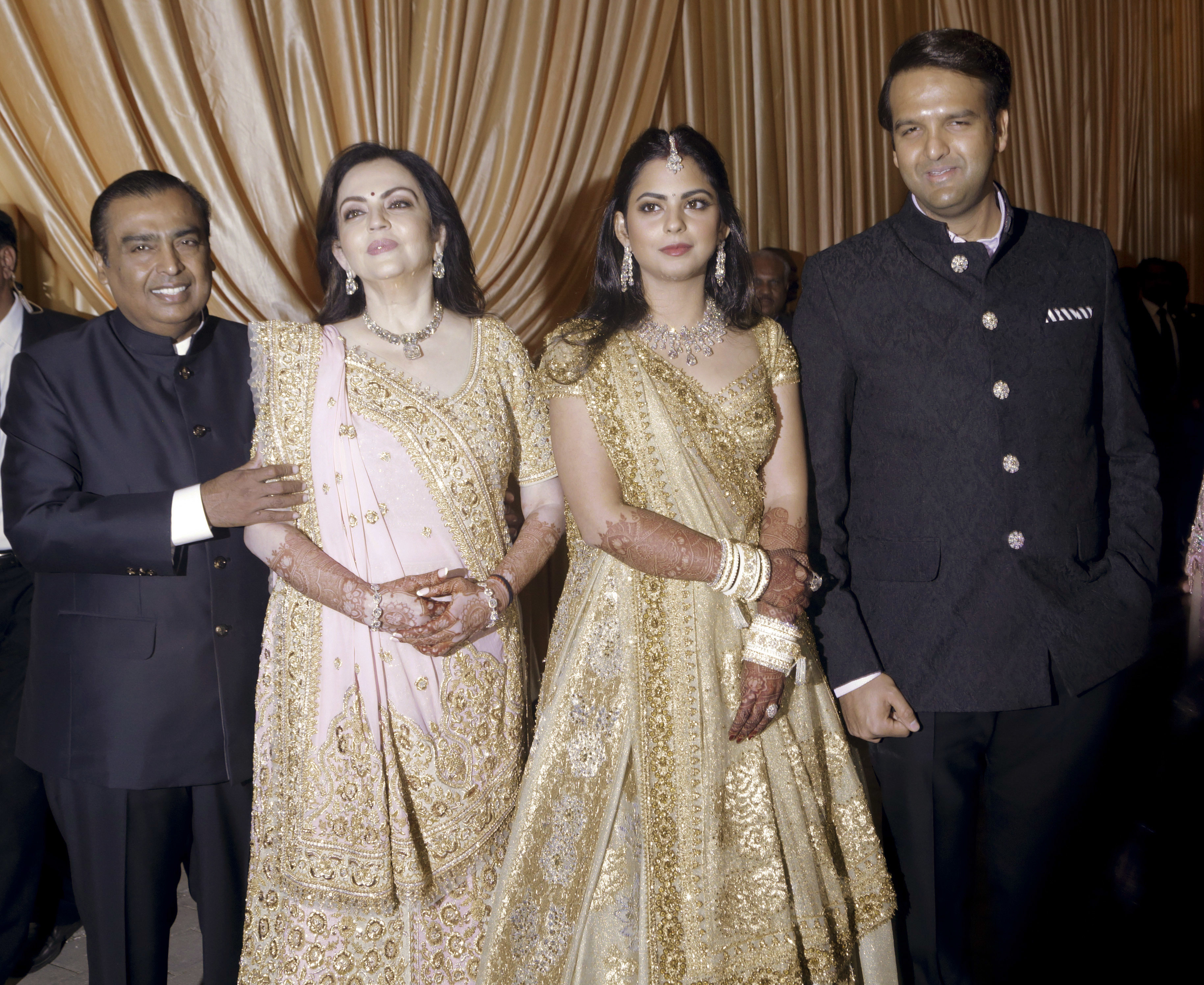 Reliance Industries Chairman Mukesh Ambani, his wife Nita Ambani, his daughter Isha and groom Anand Piramal, pose during Isha and Arnand wedding reception in Mumbai, India - AP