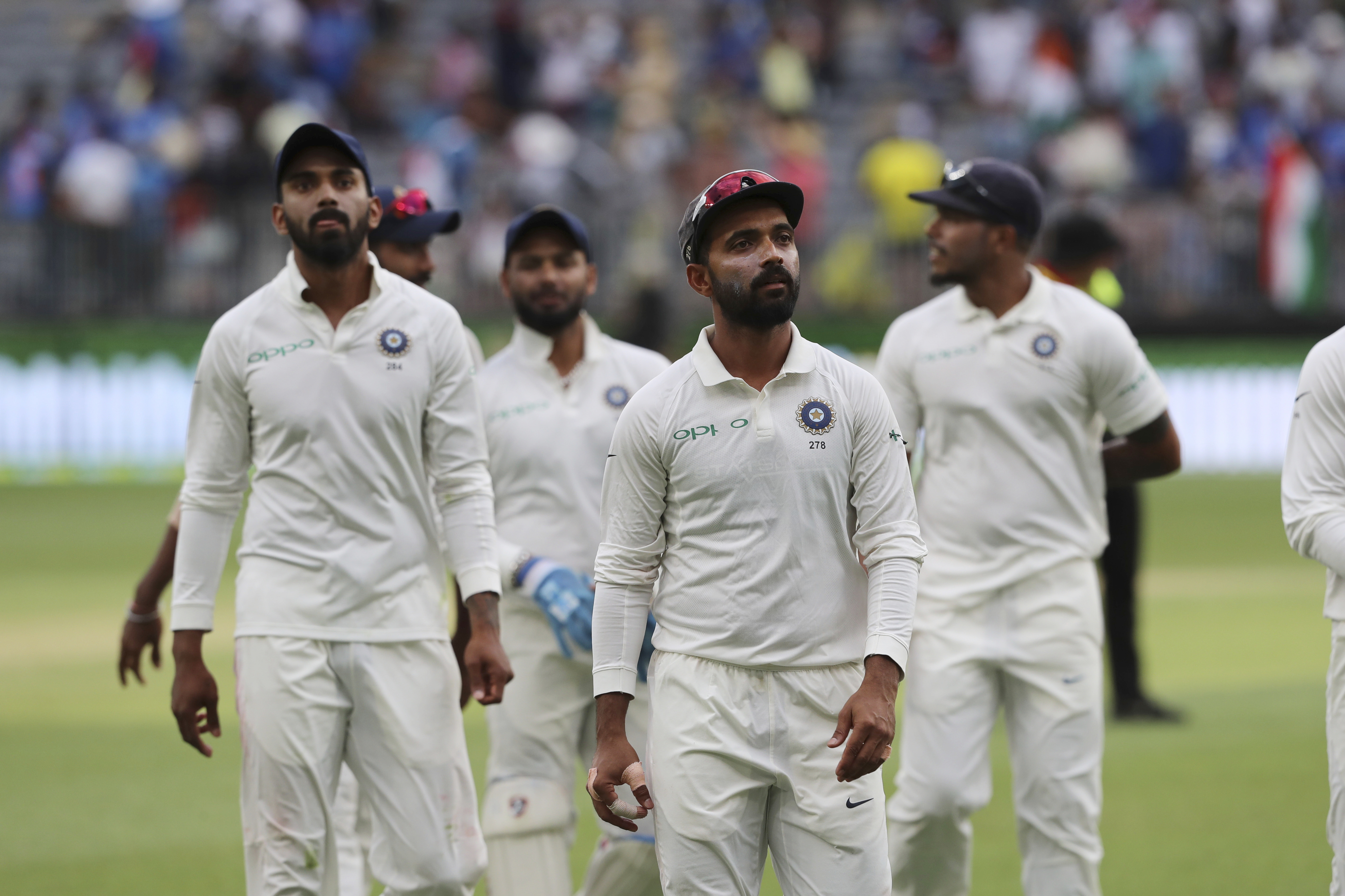 India's Ajinkya Rahane, second right, leads his teammates off the ground at the conclusion of the third days play in the second cricket test between Australia and India in Perth, Australia - AP