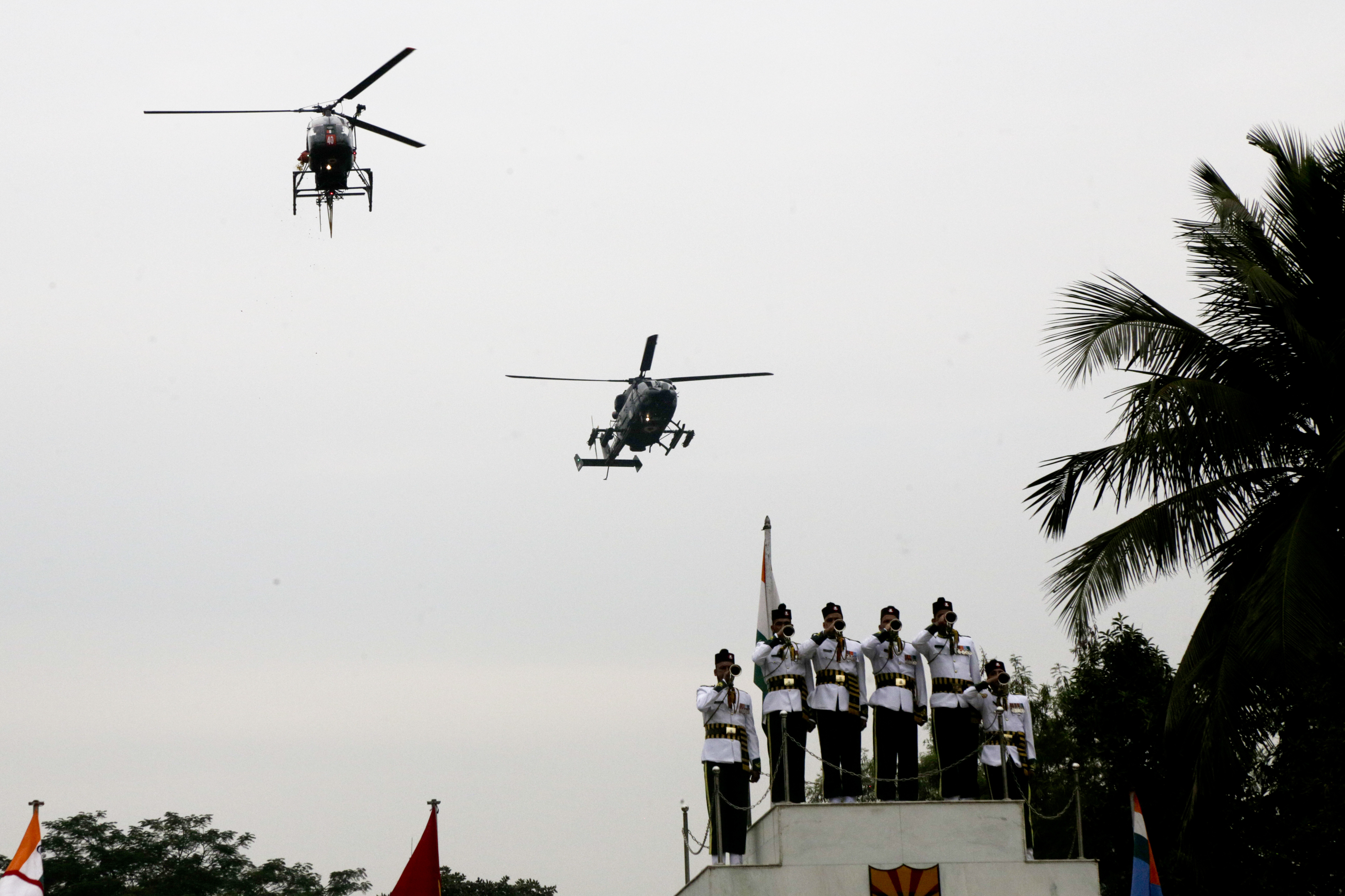 Indian army buglers perform as helicopters fly past the base of martyrs column, to pay tribute to war heroes on Vijay Divas, or Victory Day in Kolkata, India - AP