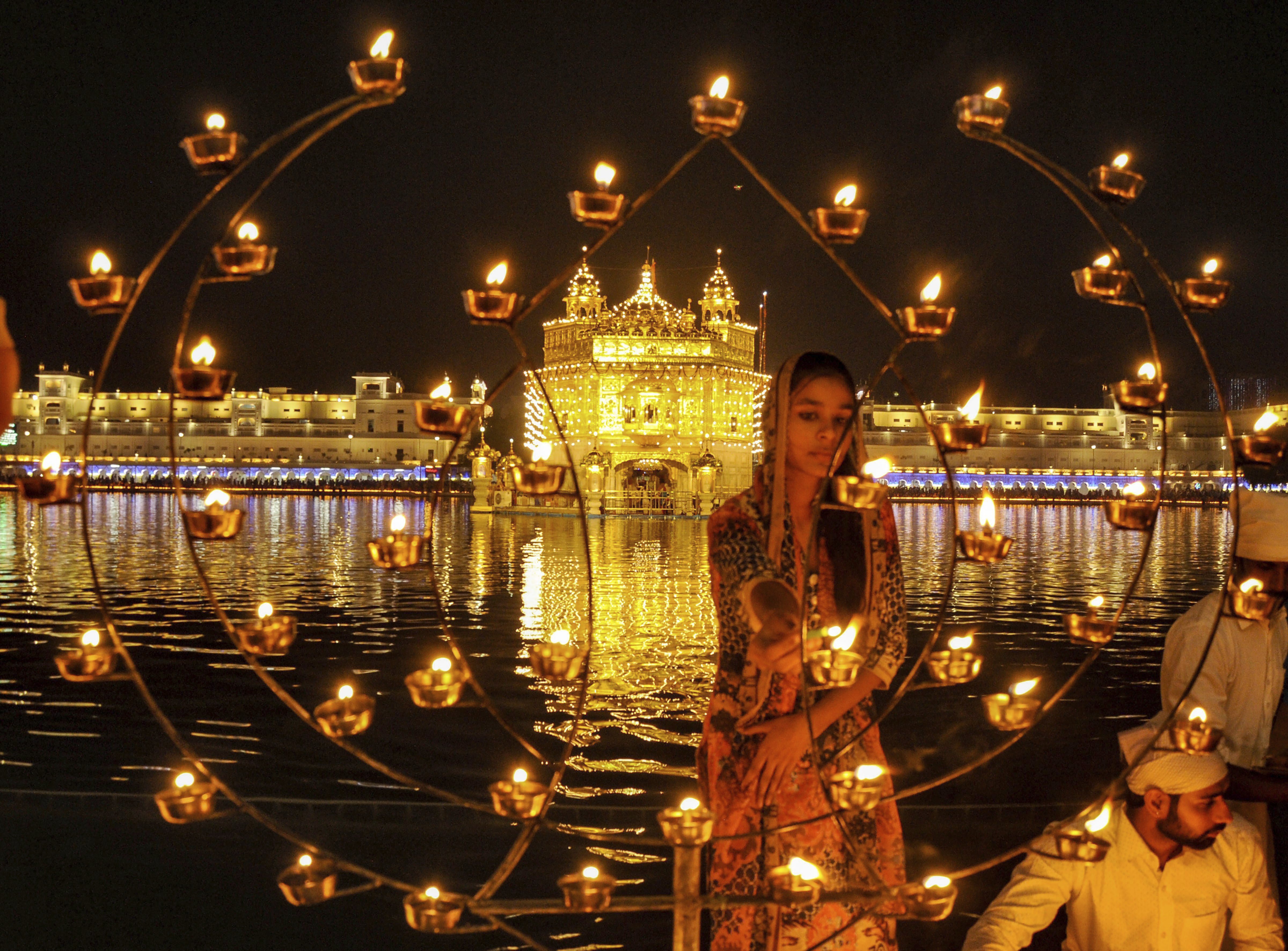 Devotees light candles at Sri Harmandir Sahib (Golden Temple) on the occasion of the 484th birth anniversary of fourth Sikh Guru, Guru Ramdass Ji, in Amritsar - PTI