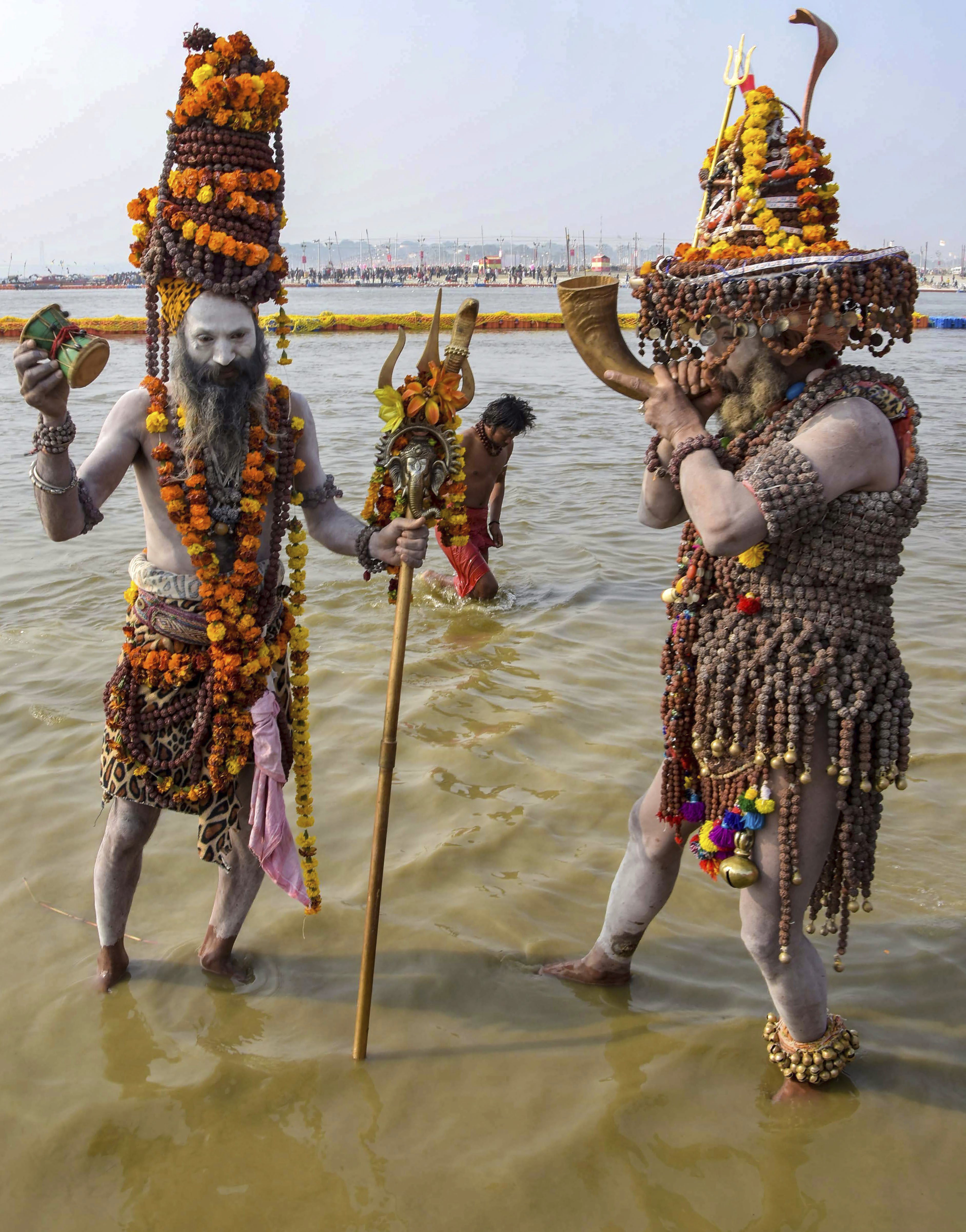 Sadhus play instruments during a ritual for 'Ganga Pujan' ceremony, in Allahabad - PTI