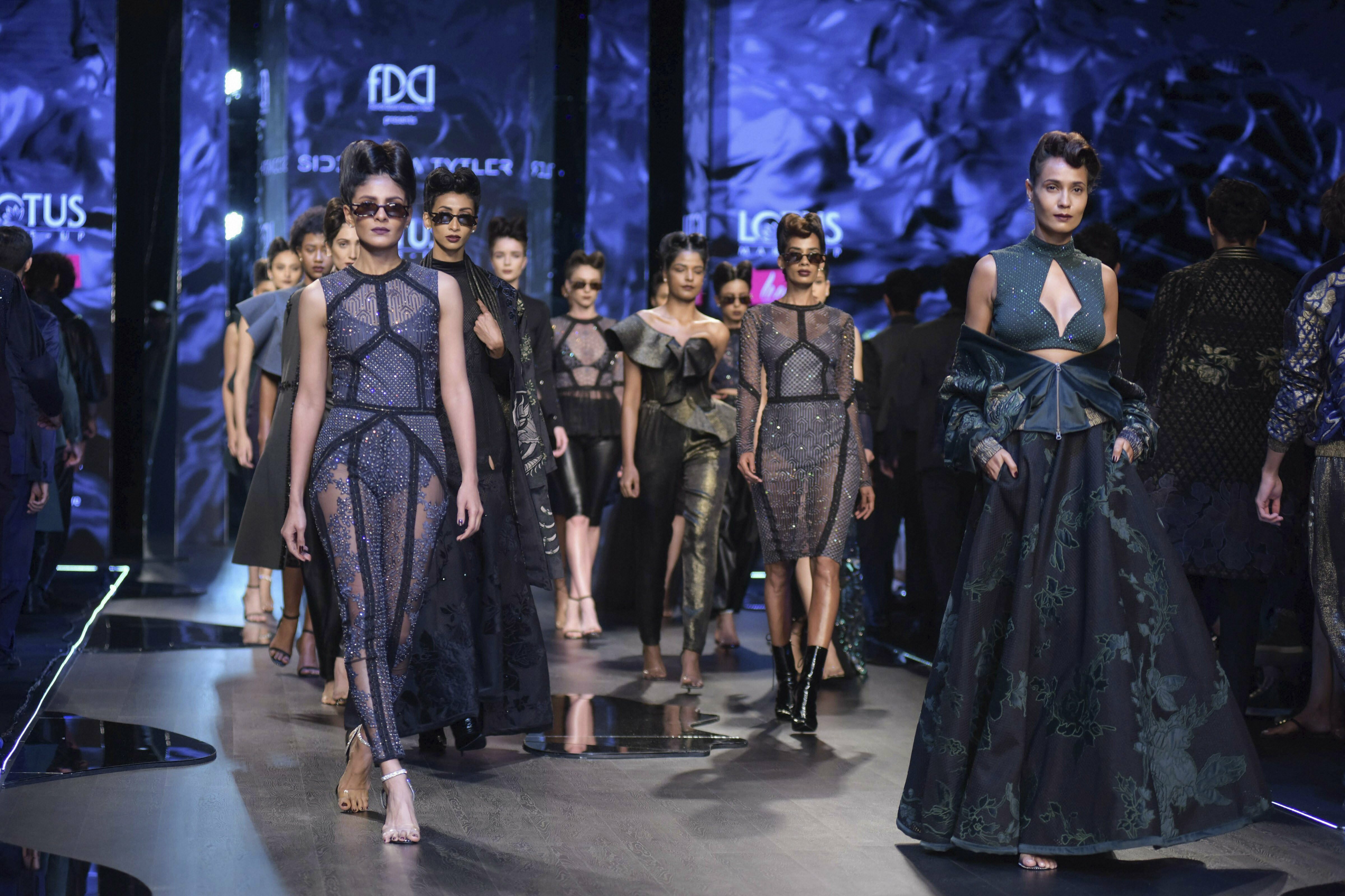 Models walk the ramp to showcase work of designer Siddartha Tytler during the India Fashion Week, in New Delhi - PTI