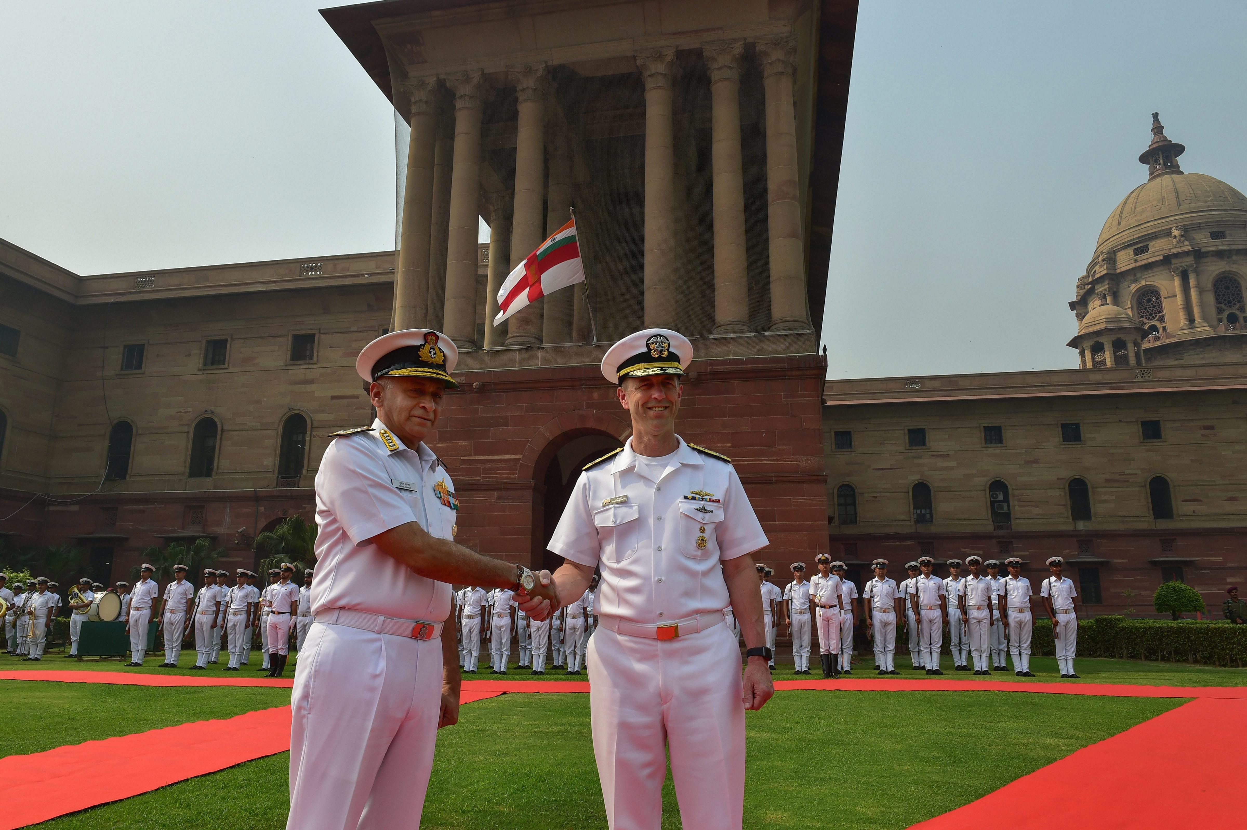 Indian Navy Chief Admiral Sunil Lanba shakes hands with US Navy, Admiral John Michael Richardson, during guard of honour at South Block, in New Delhi - PTI