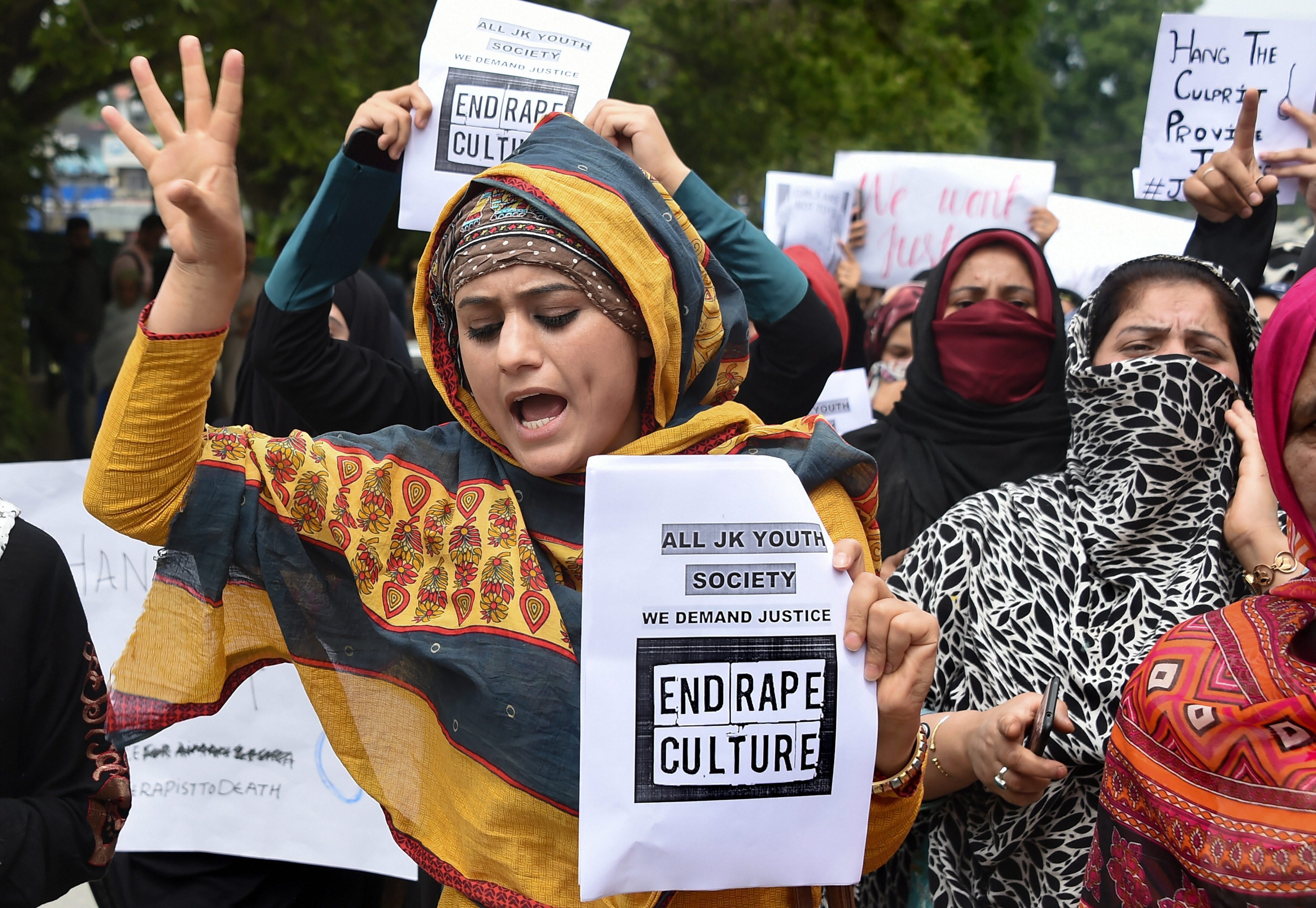 Protesters hold placards as they shout slogans during a protest against the alleged rape of a three-year-old girl by a local in Bandipora district of Jammu and Kashmir, in Srinagar - PTI