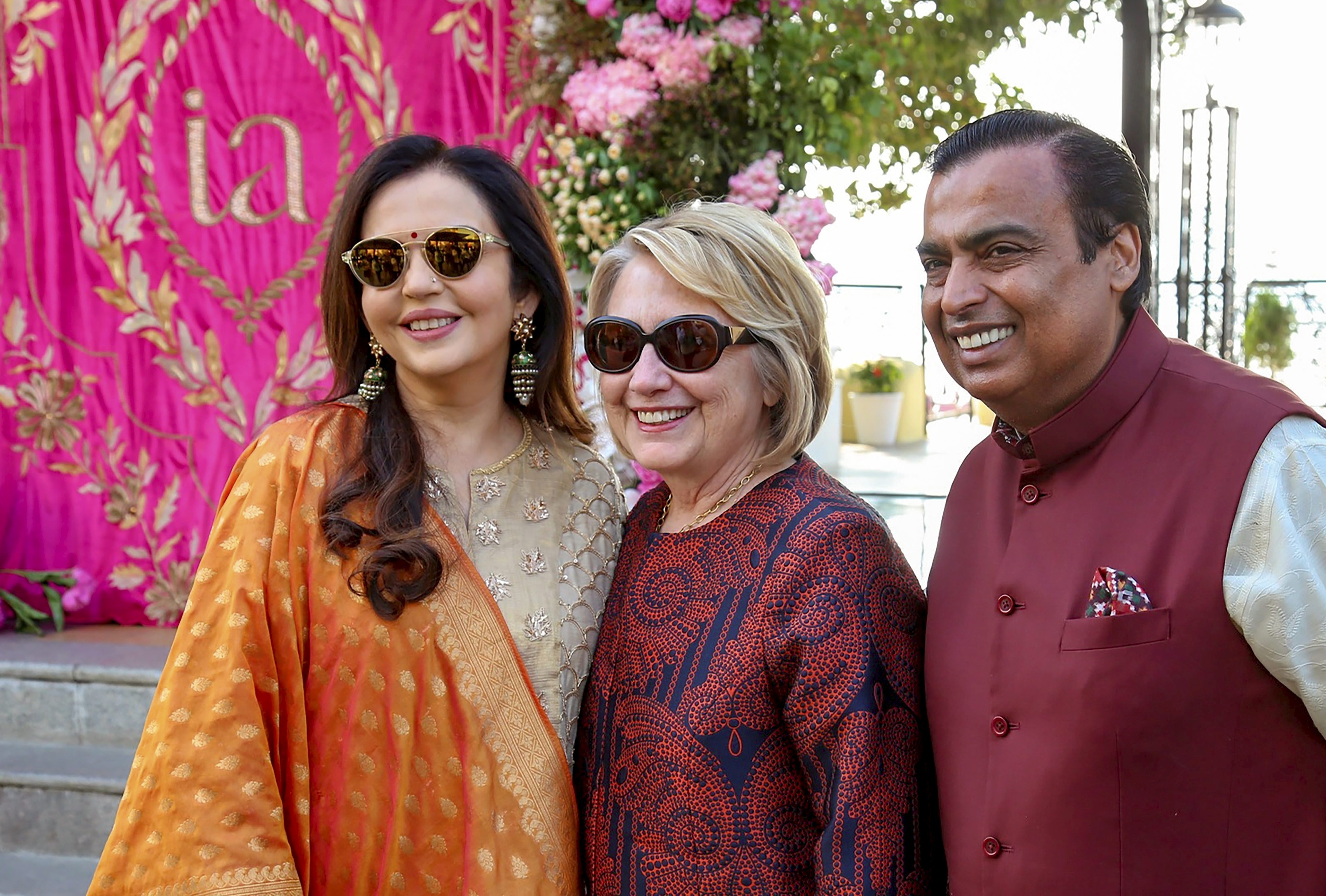 Reliance Group Chairman Mukesh Ambani and wife Nita Ambani pose for photos with former US Secretary of state Hillary Clinton as Clinton arrives to attend the pre-wedding celebration of Isha Ambani, in Udaipur - PTI
