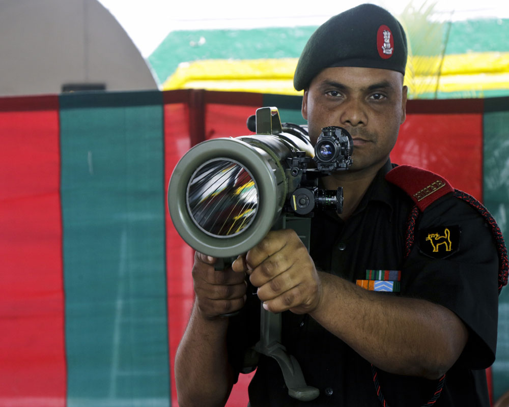 An Indian army soldier demonstrates a weapon during an interactive session with media ahead of Vijay Divas or Victory Day in war of liberation, in Kolkata - AP