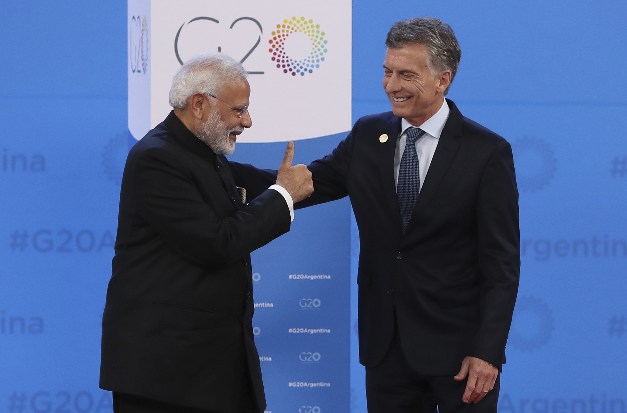 India's Prime Minister Narendra Modi gives a thumbs up as Argentina's President Mauricio Macri welcomes him to the start of the G20 summit in Buenos Aires - AP