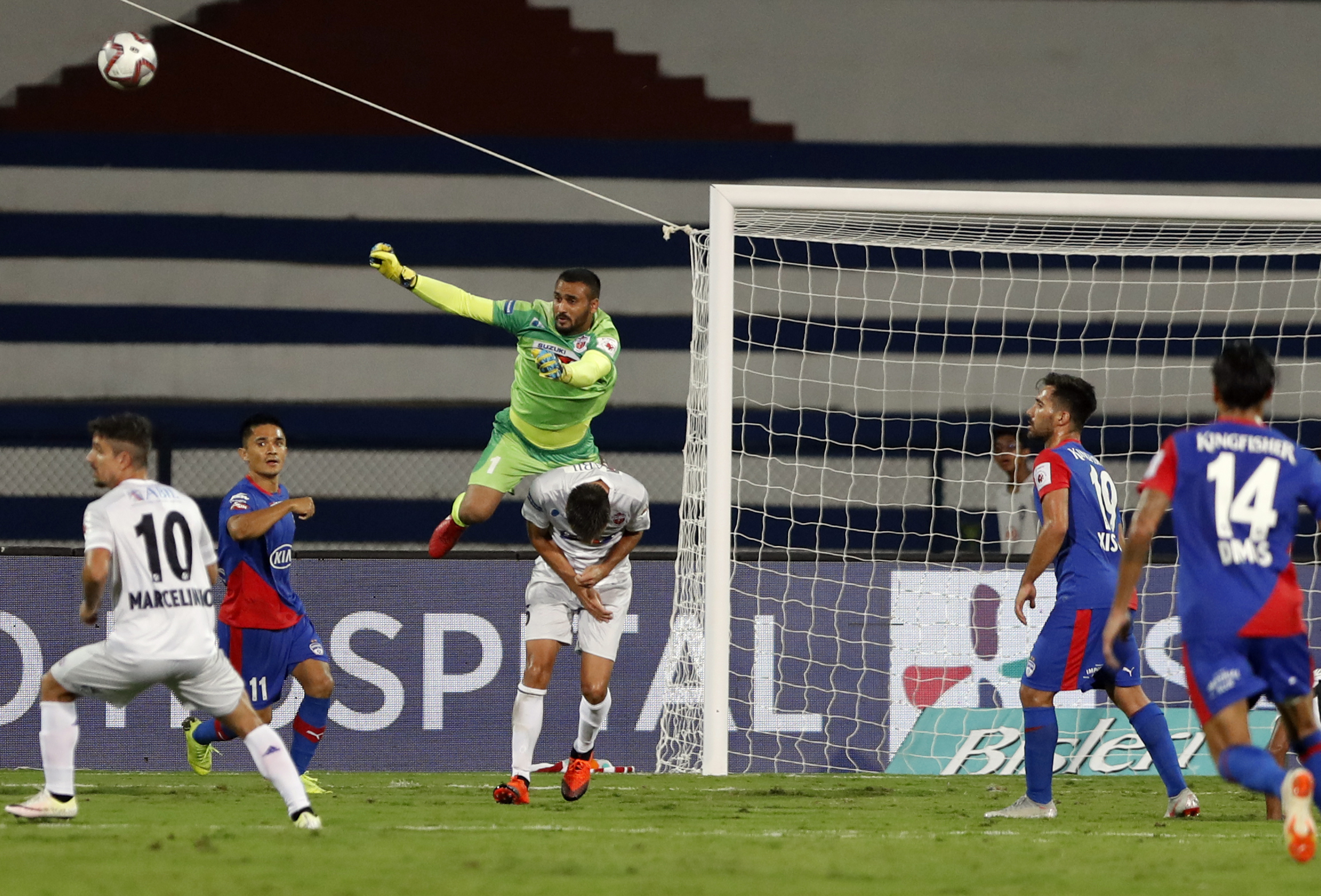 FC Pune City goalkeeper Kamaljit Singh, in green, jumps to save a goal during the Hero Indian Super League (ISL) soccer match between Bengaluru FC and FC Pune City in Bangalore - AP