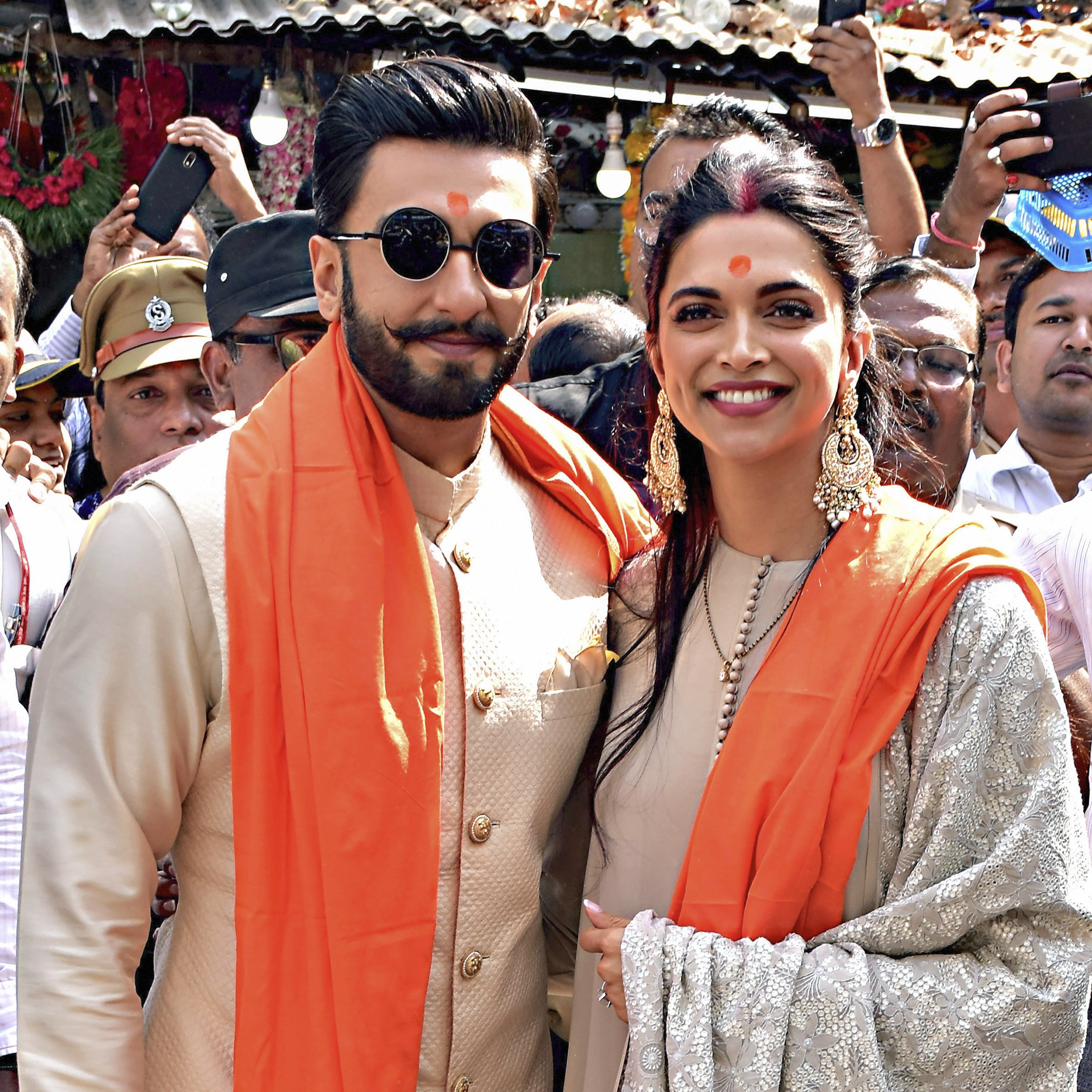 Newly-wed Bollywood actors Deepika Padukone and Ranveer Singh pose for photos on their visit to Siddhivinayak Temple, in Mumbai - PTI