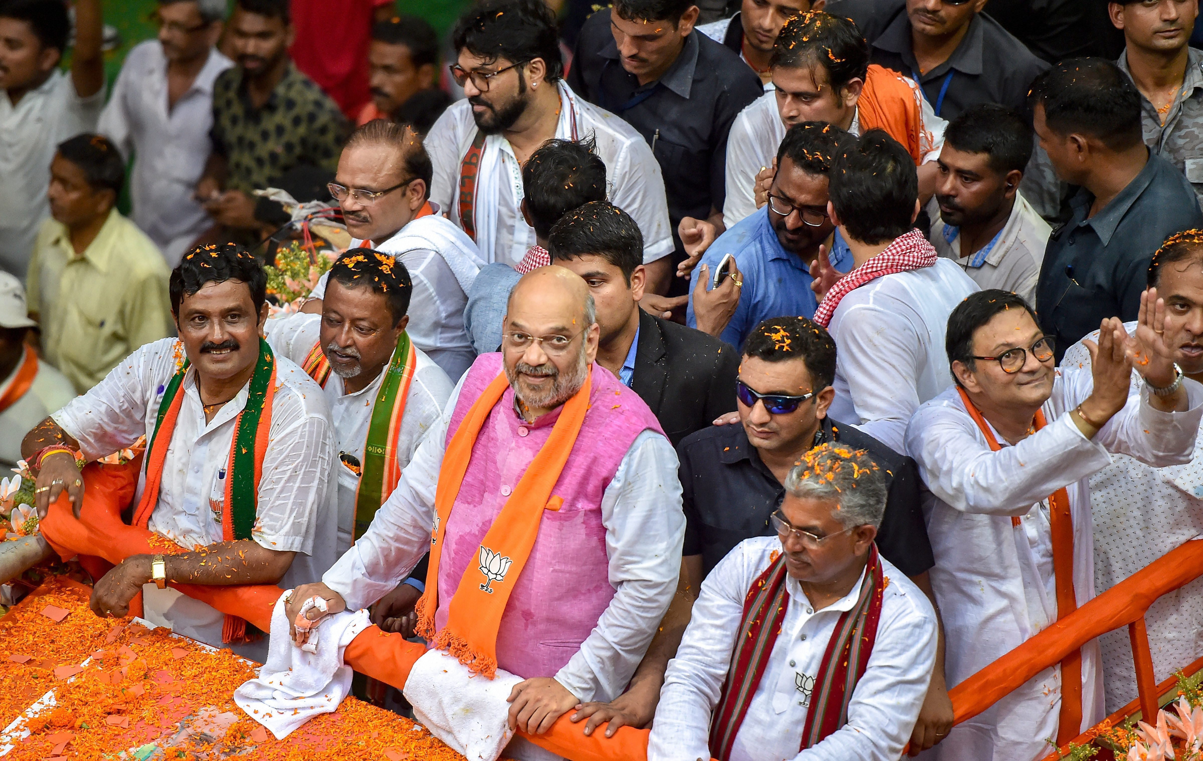 BJP National President Amit Shah during an election roadshow in support of party's north Kolkata seat candidate Rahul Sinha for the last phase of Lok Sabha polls, in Kolkata - PTI