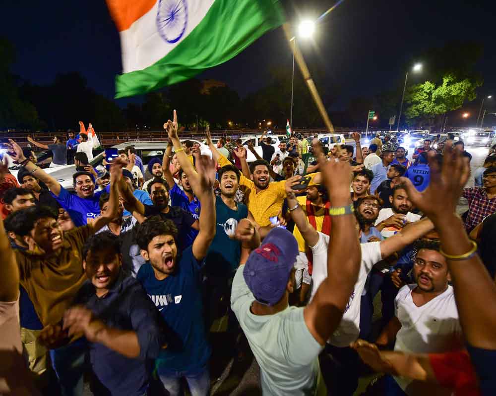People celebrating India wins Cricket World Cup match between India and Pakistan at Old Trafford in Manchester,at India Gate in New Delhi - PTI