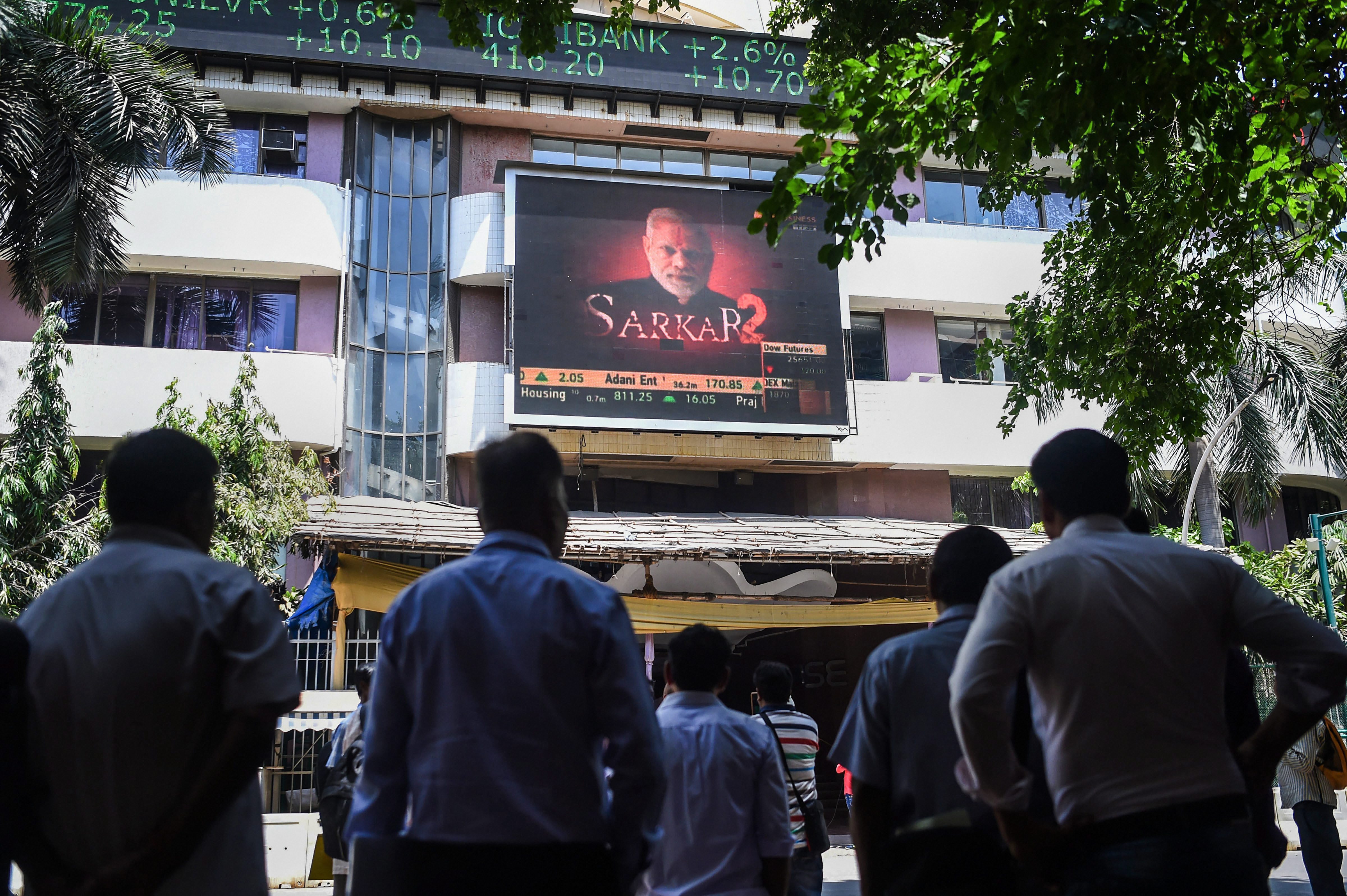 People look at the screen on BSE building as the sensex soars on the vote counting day for the 2019 Lok Sabha polls, in Mumbai - PTI