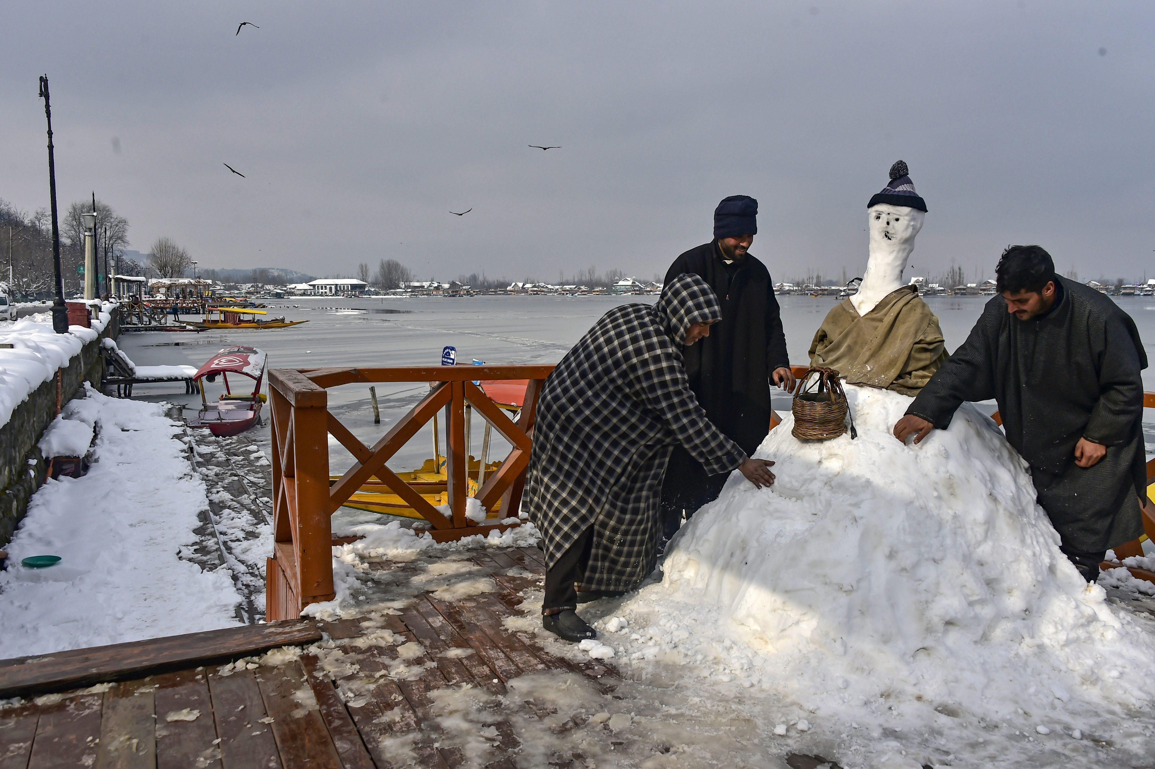 People make a snow man after heavy snowfall , in Srinagar - PTI