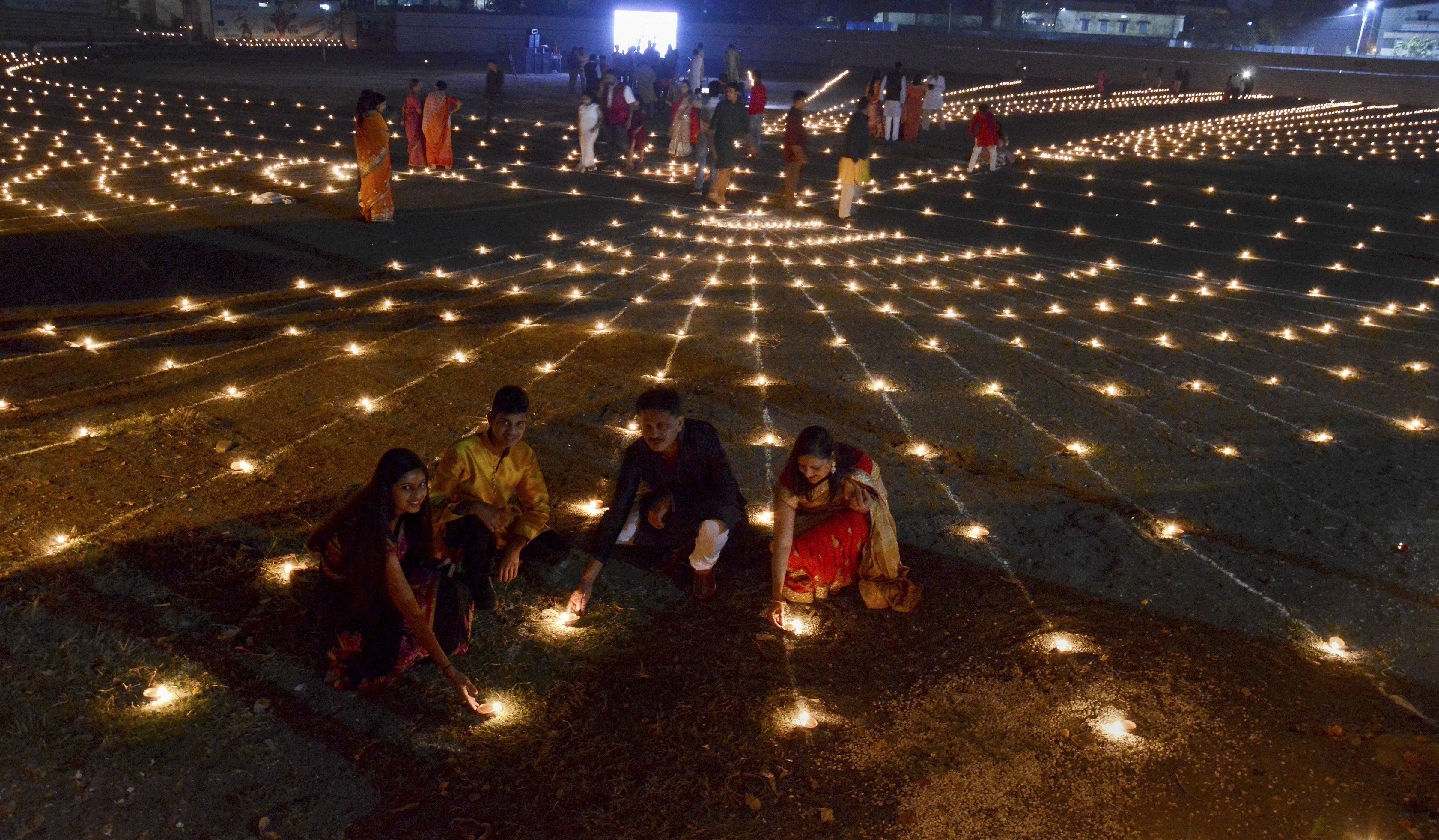 People light earthen lamps for soldiers on the occasion of 'Diwali' festival at Ravi Shankar Shukla Stadium, in Jabalpur - PTI