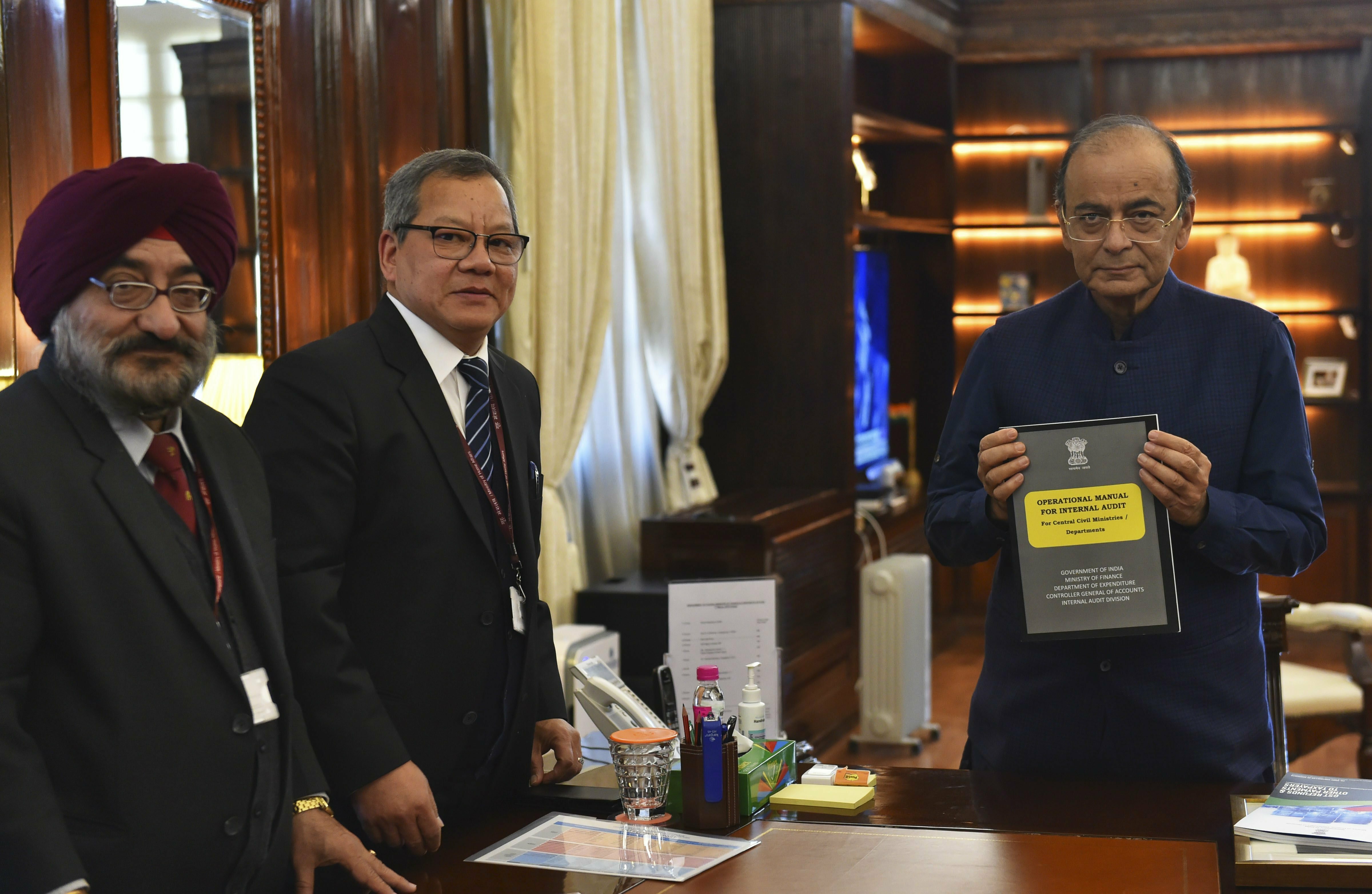 Finance Minister Arun Jaitley with Controller General of Accounts Anthony Lianzuala releases the 
