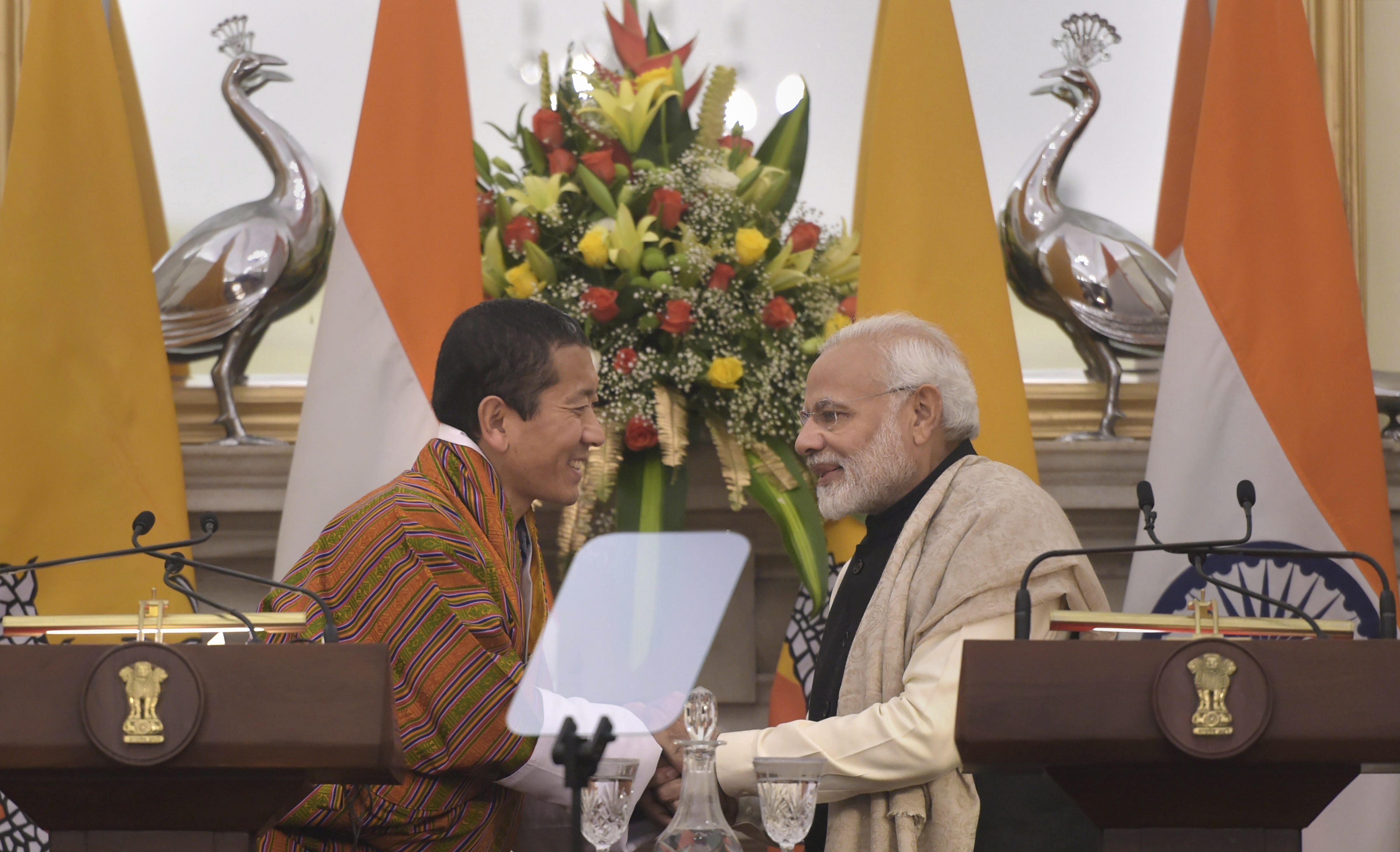 Prime Minister Narendra Modi shakes hands with his Bhutanese counterpart Lotay Tshering after a joint statement at Hyderabad House, in New Delhi - PTI
