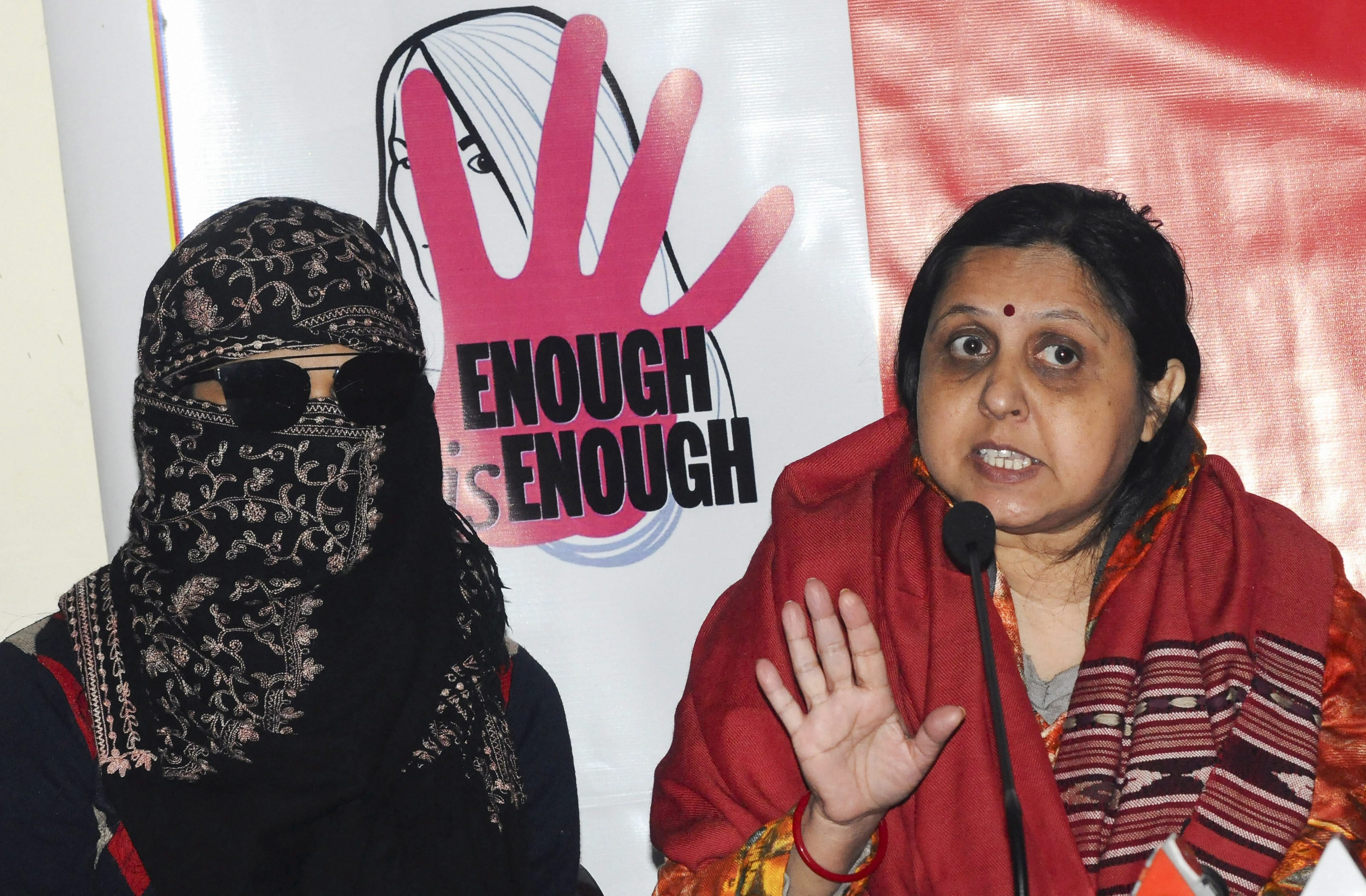Advocate and mediator Varuna Bhandari, with an employee of Doordarshan Television Network who was allegedly sexually harassed by superiors, addresses a press conference in New Delhi - PTI