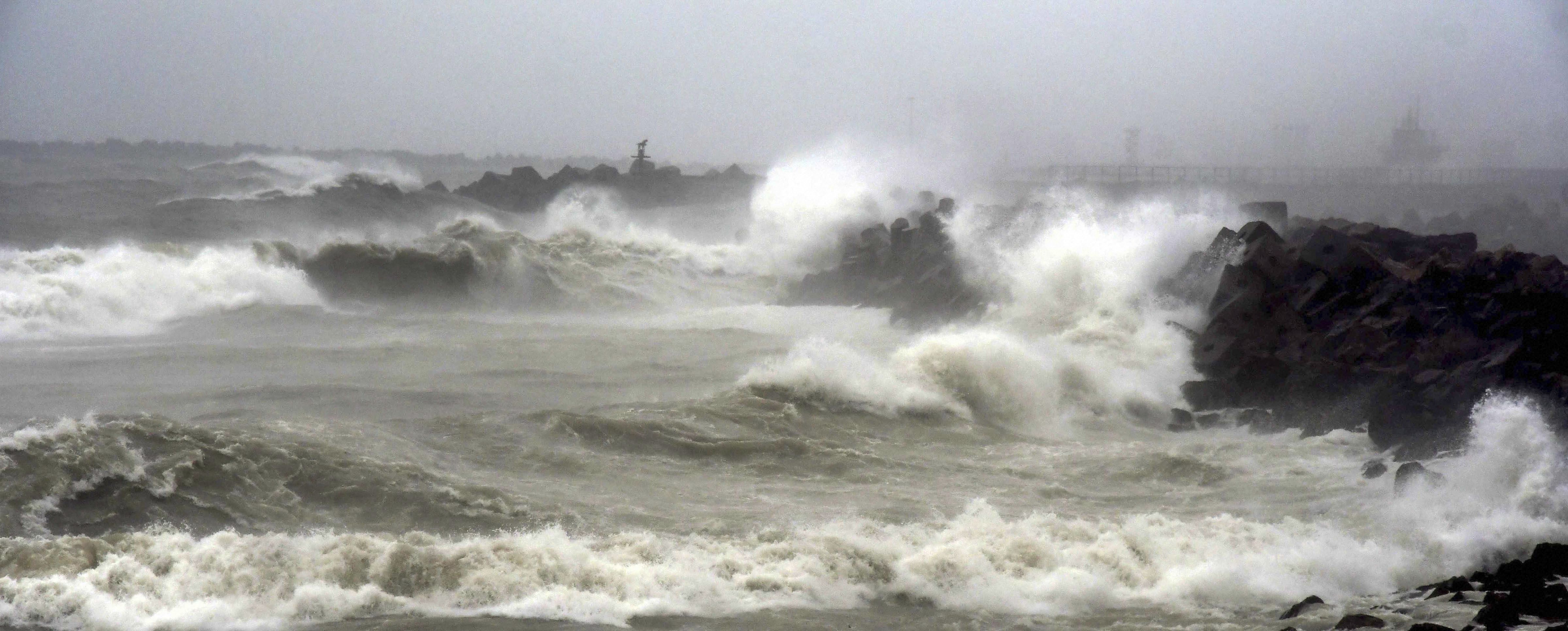 Waves crash on a shore during heavy rainfall as Cyclone Phethai barrels through coastal Andhra Pradesh, in Visakhapatnam - PTI