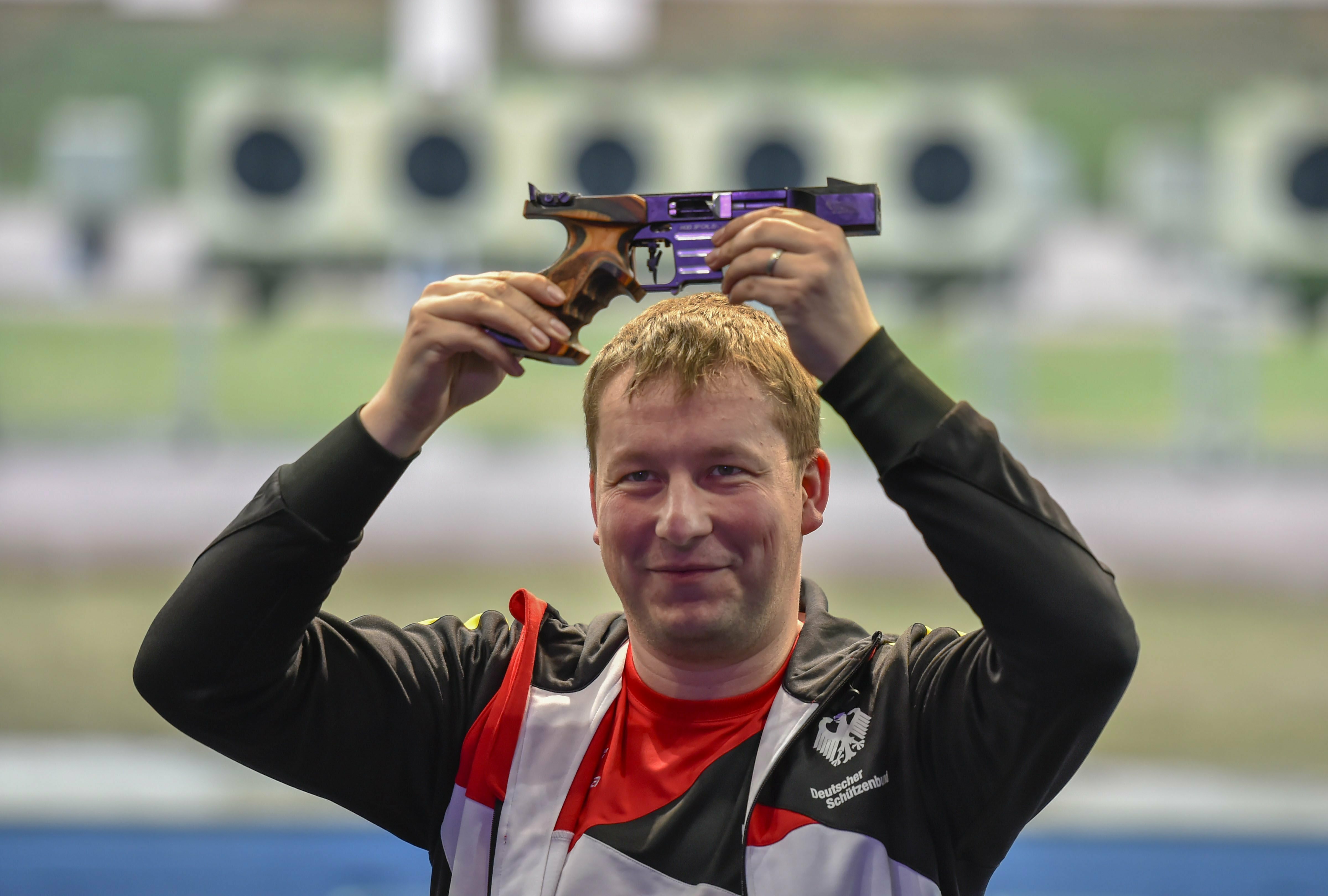 German shooter Christian Reitz celebrates after winning the men's 25m rapid fire pistol final shooting event of ISSF World Cup Rifle/Pistol, at Dr Karni Singh Shooting Range in New Delhi - PTI