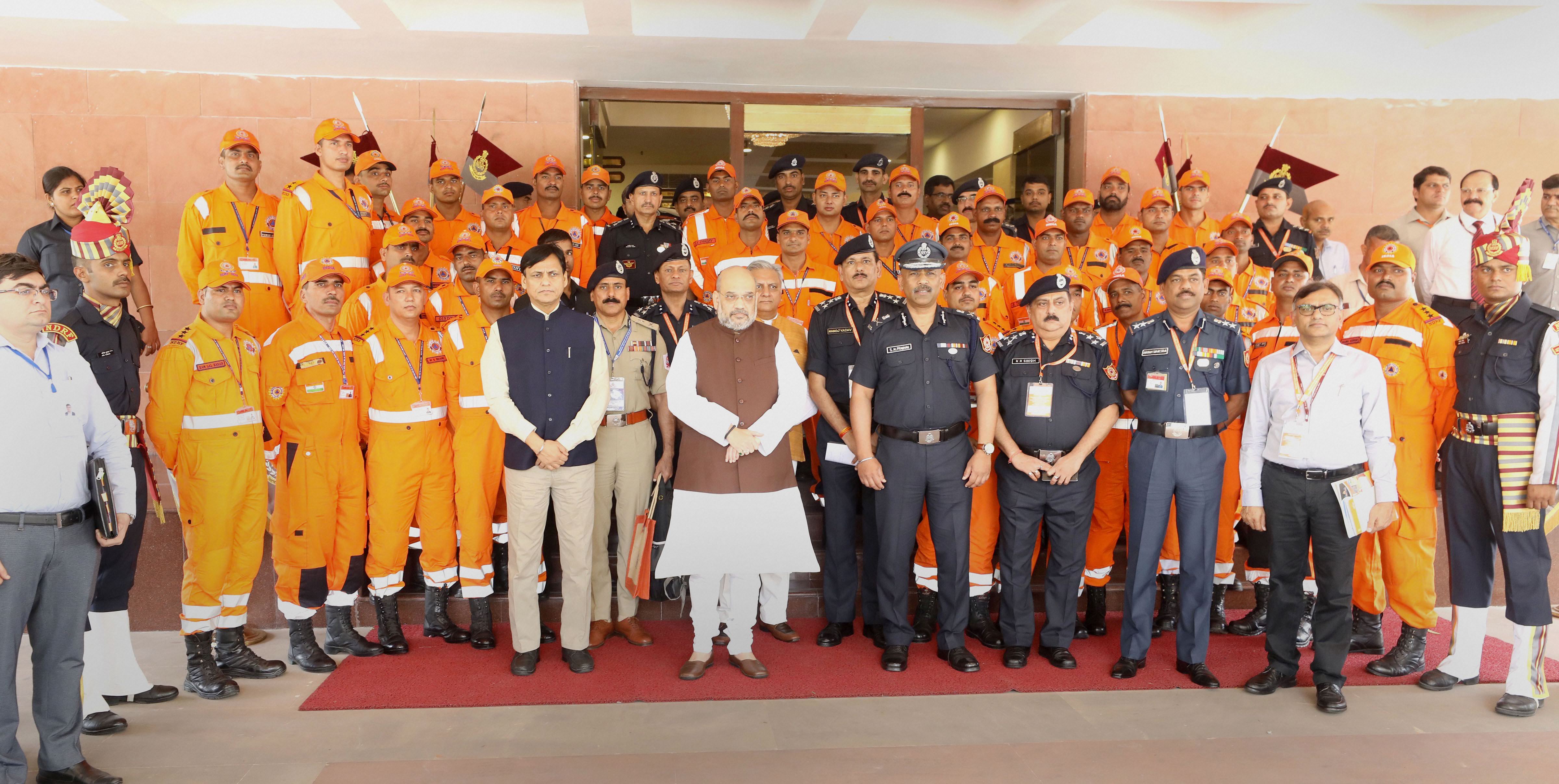 Union Home Minister Amit Shah with NDRF personnel, at the annual conference on capacity building of SDRFs, Civil Defence, Home Guards and Fire Services, organised by the NDRF - PTI