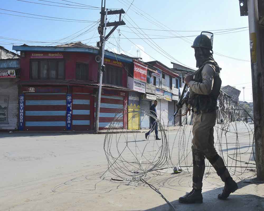 A security personnel stands guard during restrictions, in Srinagar - PTI