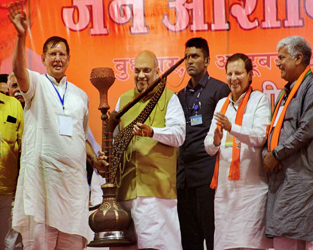 Home Minister Amit Shah being presented a 'hookah' during a public meeting in Rohtak district - PTI
