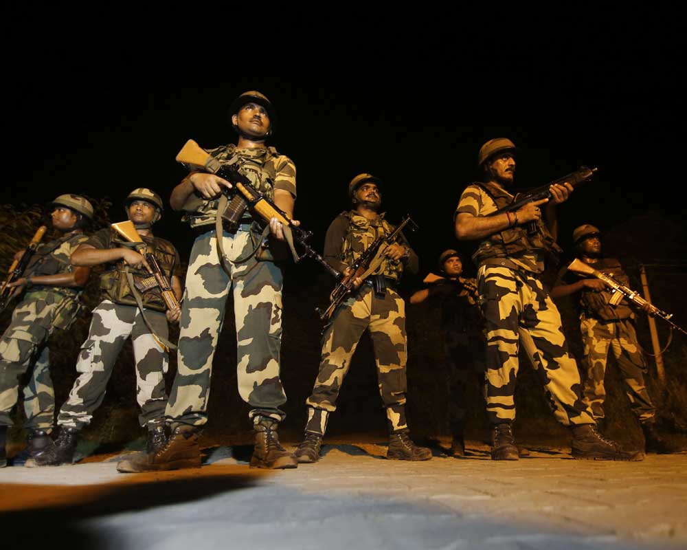 Border Security Force (BSF) soldiers patrol near International border on the outskirts of Jammu - PTI