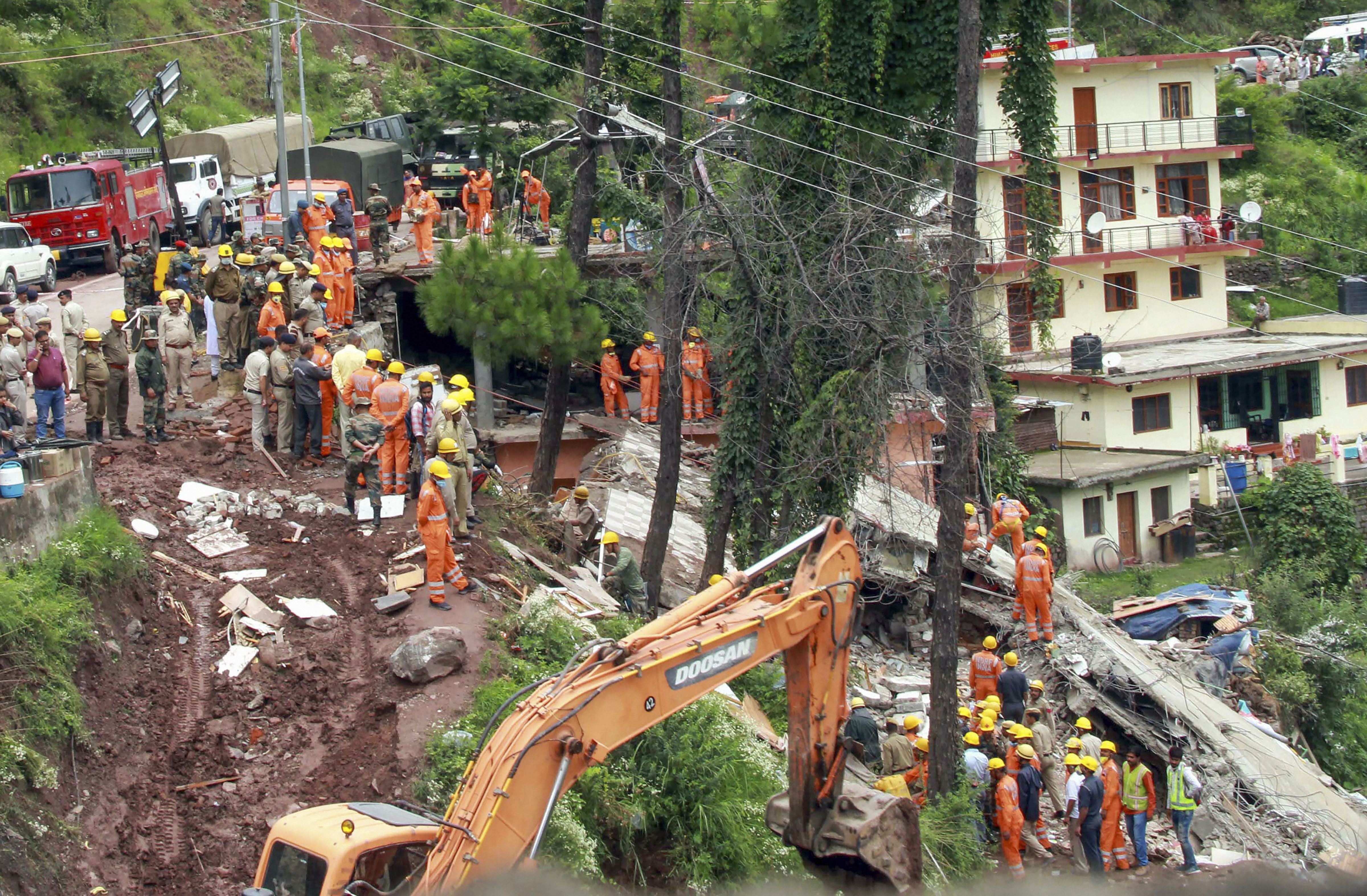 Rescue and relief work underway after a building located on the Nahan-Kumarhatti road which housed a restaurant  collapsed on Sunday evening after heavy rain, in Solan district - PTI