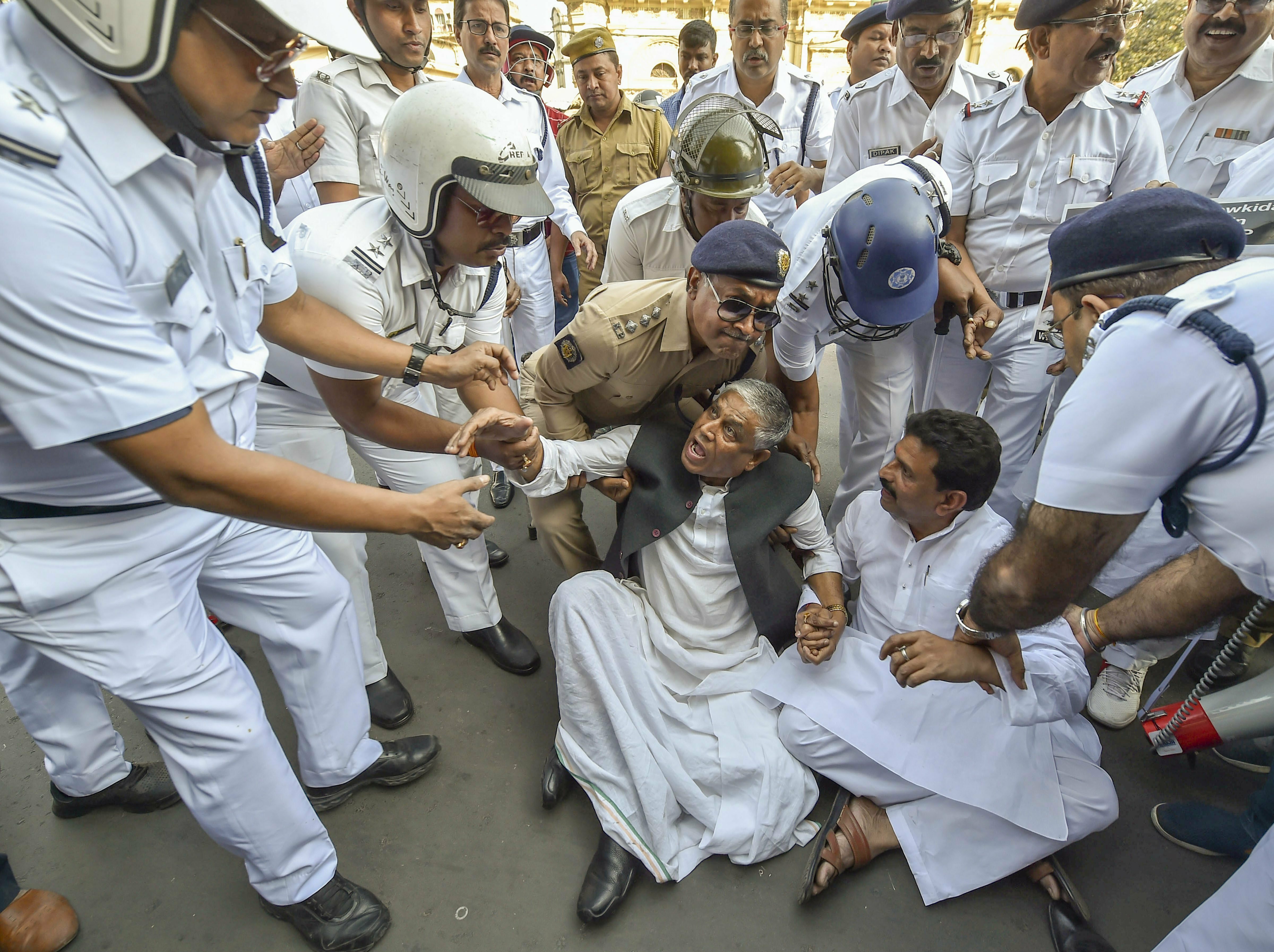 Police detain Congress MLA Abdul Mannan as he takes part in the party workers' march towards the Metro Channel for a sit-in protest to demand for justice to the chit fund investors, in Kolkata - PTI