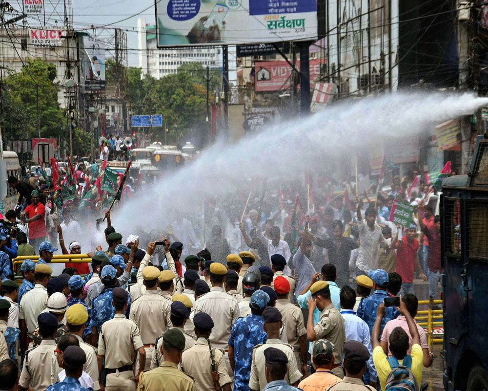 Police use water cannons to disperse Jan Adhikar Party supporters during their Vidhan Sabha gherao protest over the death of children due to Acute Encephalitis Syndrome (AES) and others issue - PTI