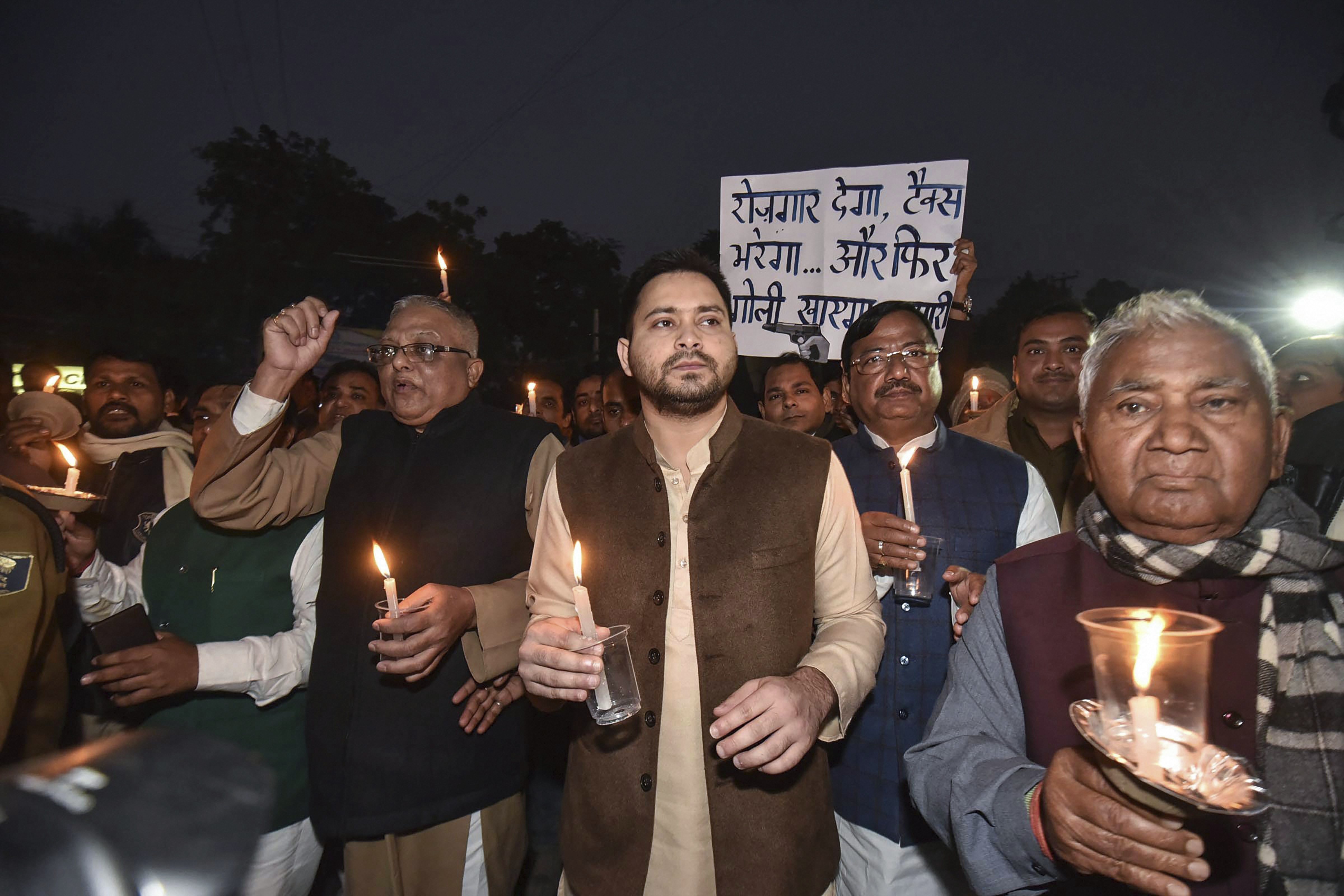 RJD leader Tejashwi Yadav with the party leaders hold a candlelight vigil demanding justice for industrialist Gunjan Khemka, in Patna - PTI