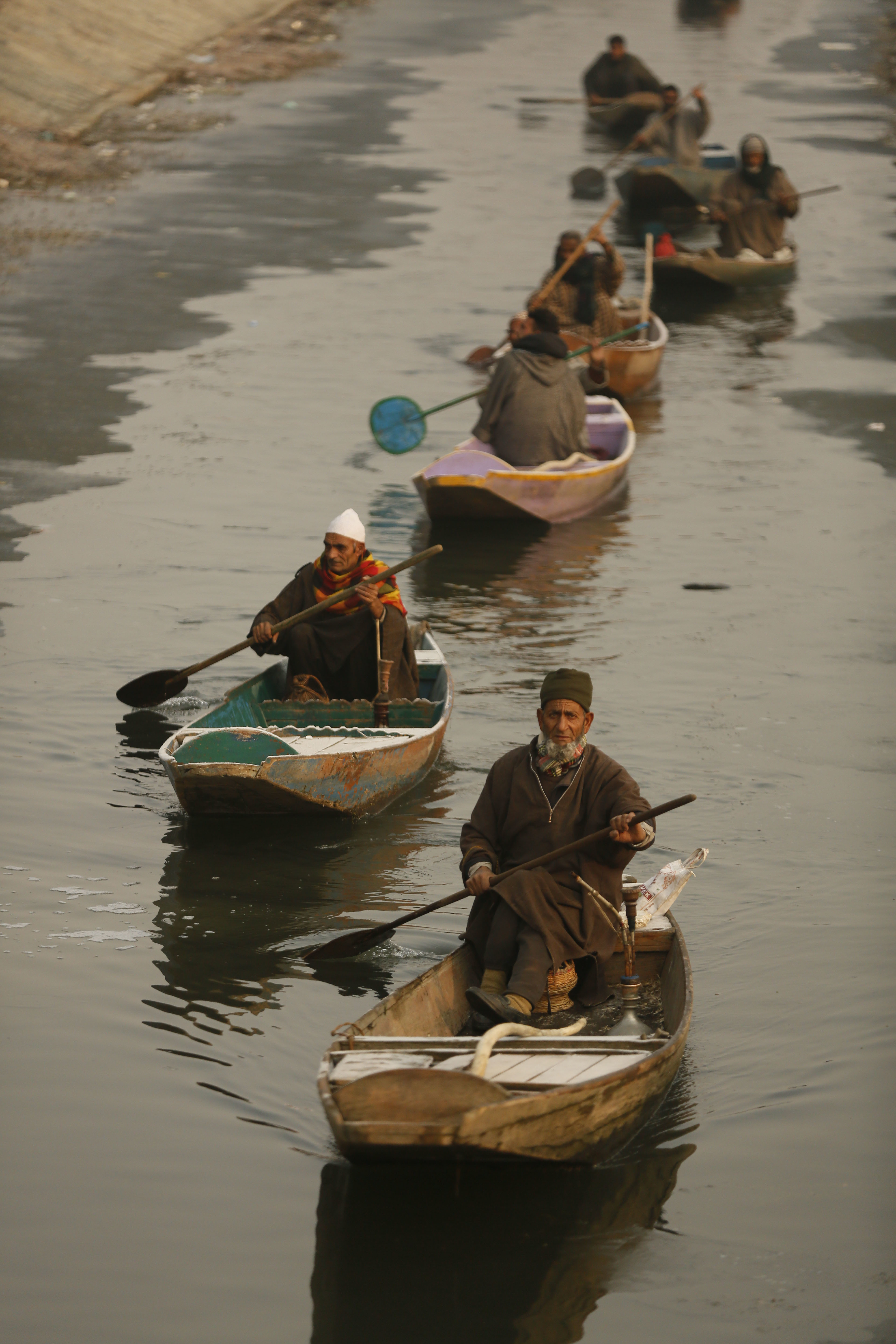 Kashmiri fishermen set off for a day's work on a cold morning in Srinagar - AP