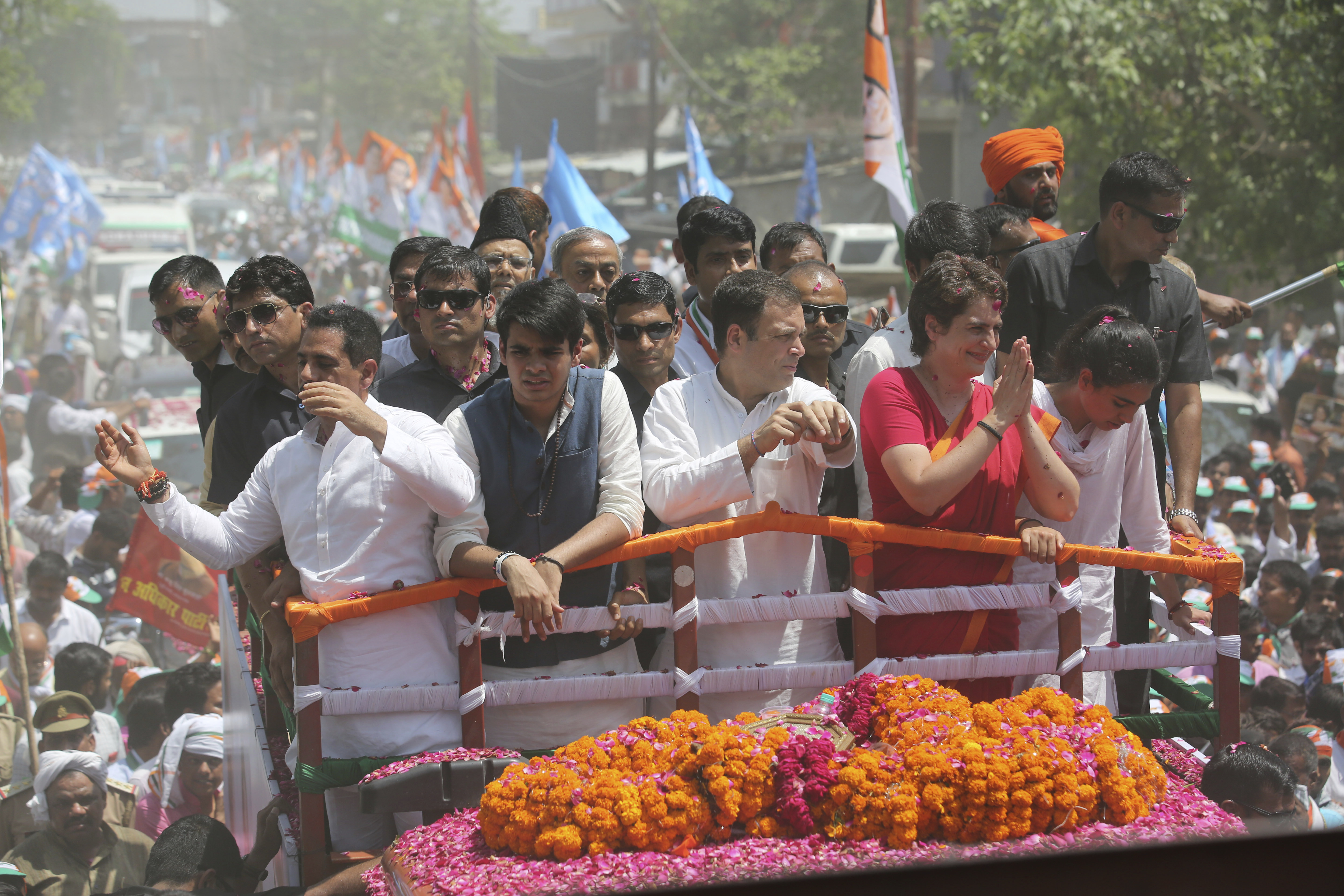 Congress party chief Rahul Gandhi, center in white, accompanied by his sister Priyanka Vadra in red arrives to file his nomination papers for the upcoming general elections in Amethi, Uttar Pradesh - AP