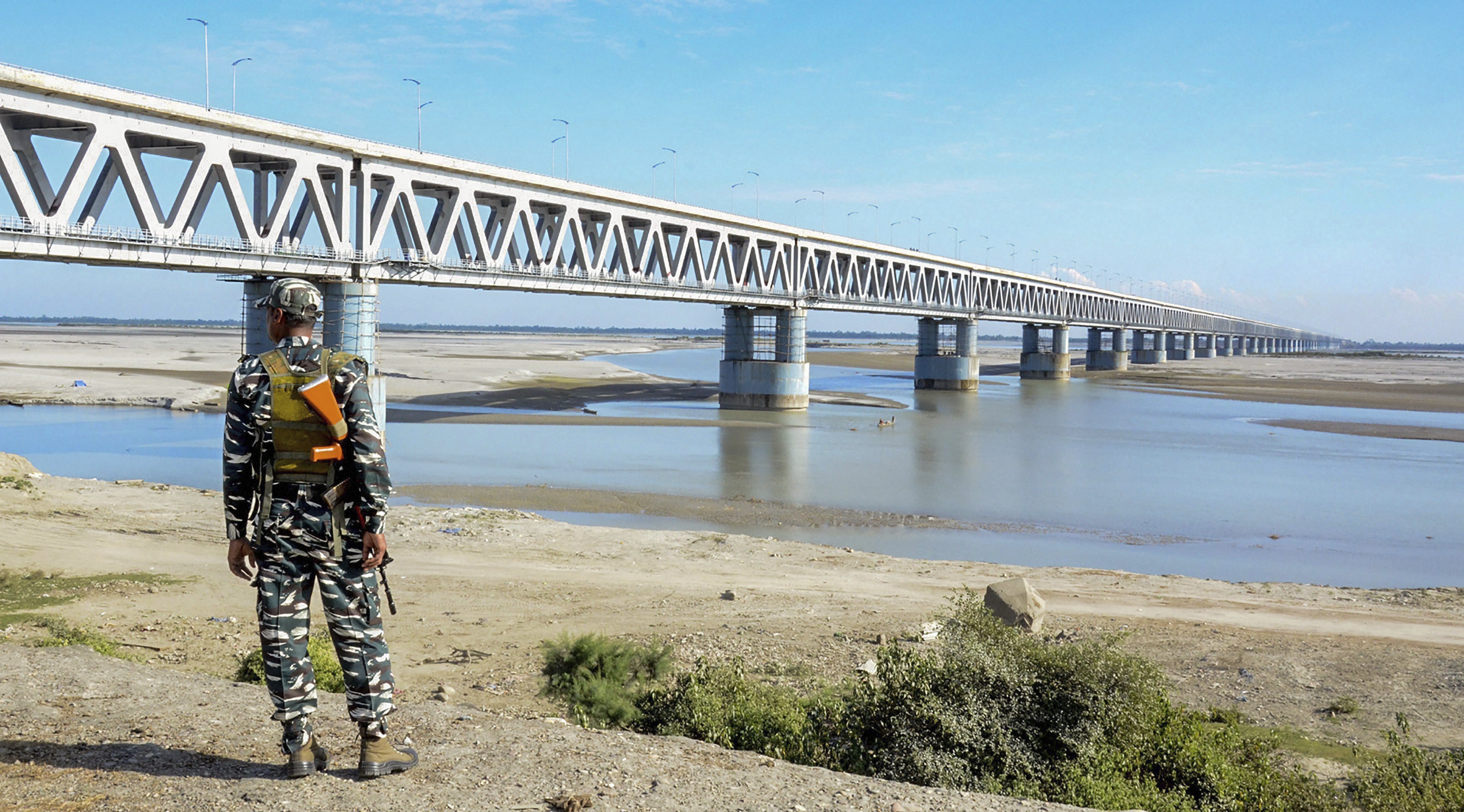 A security personnel awaits the arrival of Assam Chief Minister Sarbananda Sonowal for the inspection of Bogibell Bridge, ahead of its inauguration, in Dibrugarh - PTI
