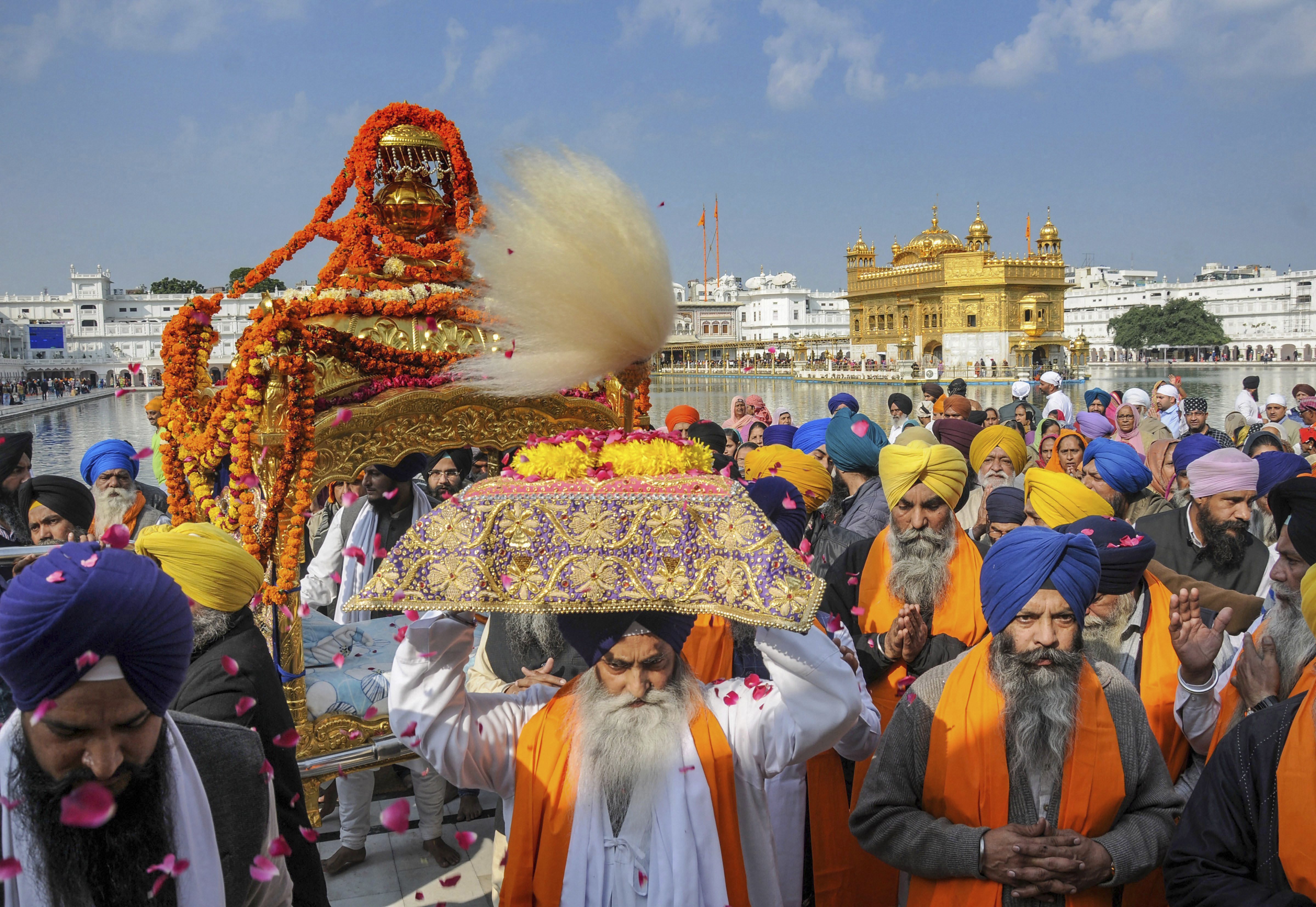 Sikh devotees participate in a 'nagar kirtan' procession at Sri Harmandir Sahib (Golden Temple) on the eve of the 343rd martyrdom day of ninth Sikh guru Guru Tegh Bahadur, in Amritsar - PTI