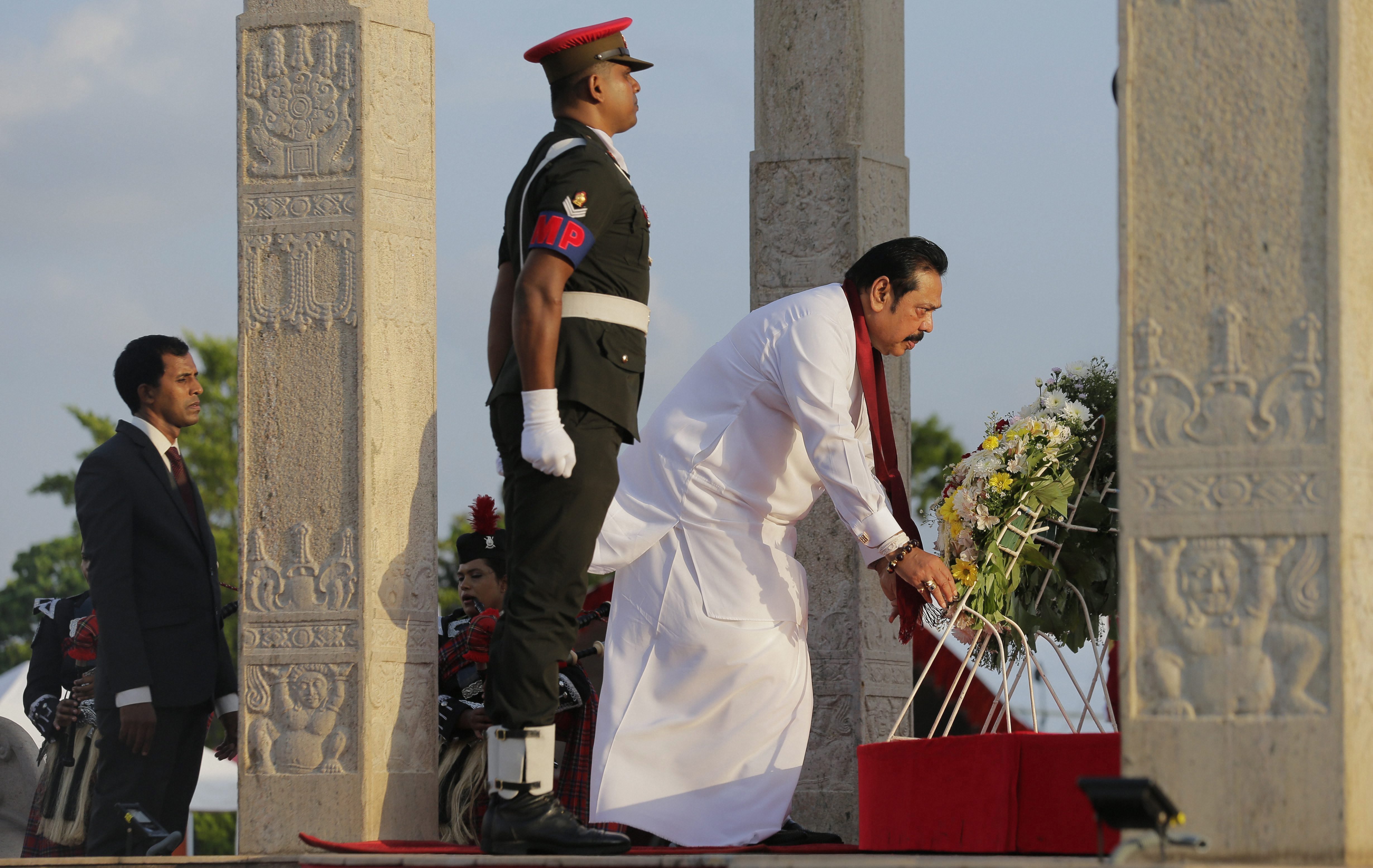 Sri Lanka's former president and current leader of the opposition Mahinda Rajapaksa, in white, places a wreath at the fallen heroes memorial during the tenth anniversary of Sri Lanka's civil war victory in Colombo, Sri Lanka - PTI