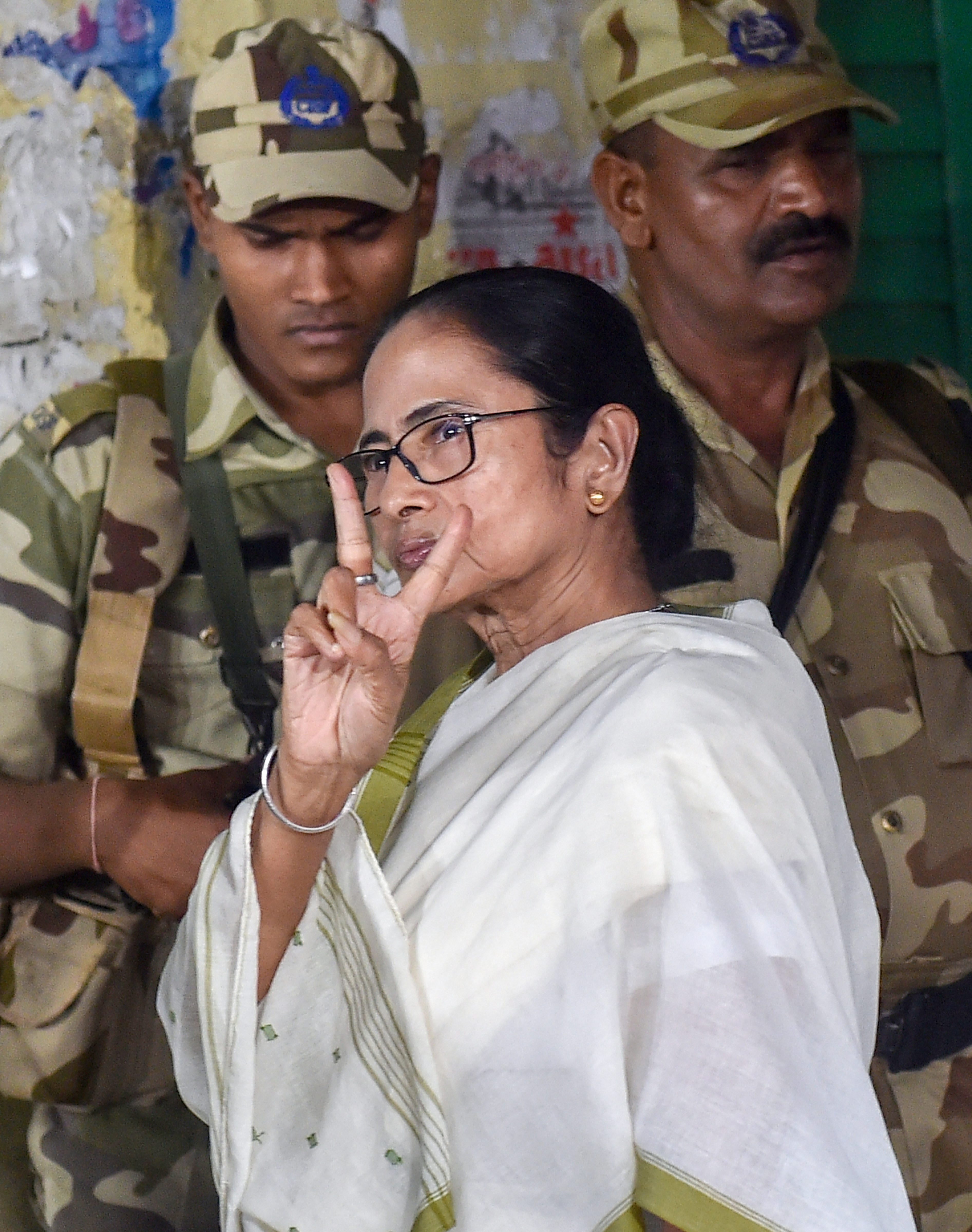 West Bengal Chief Minister and TMC Supremo Mamata Banerjee flashes victory sign after casting her vote at a polling booth during the seventh and final phase of Lok Sabha polls, in Kolkata - PTI