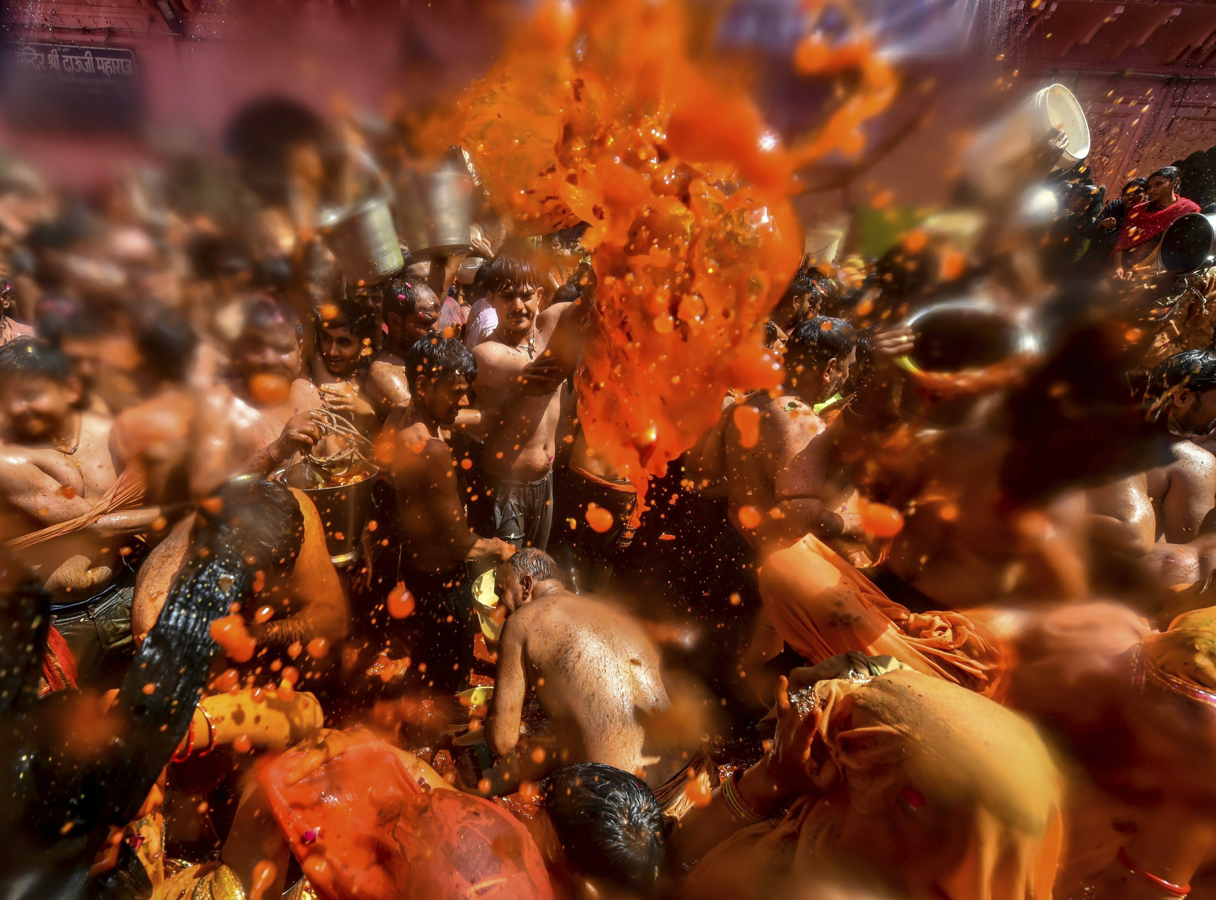 Revellers participate in Huranga, celebrated one day after the Holi festival, at Dauji Temple in Mathura - PTI