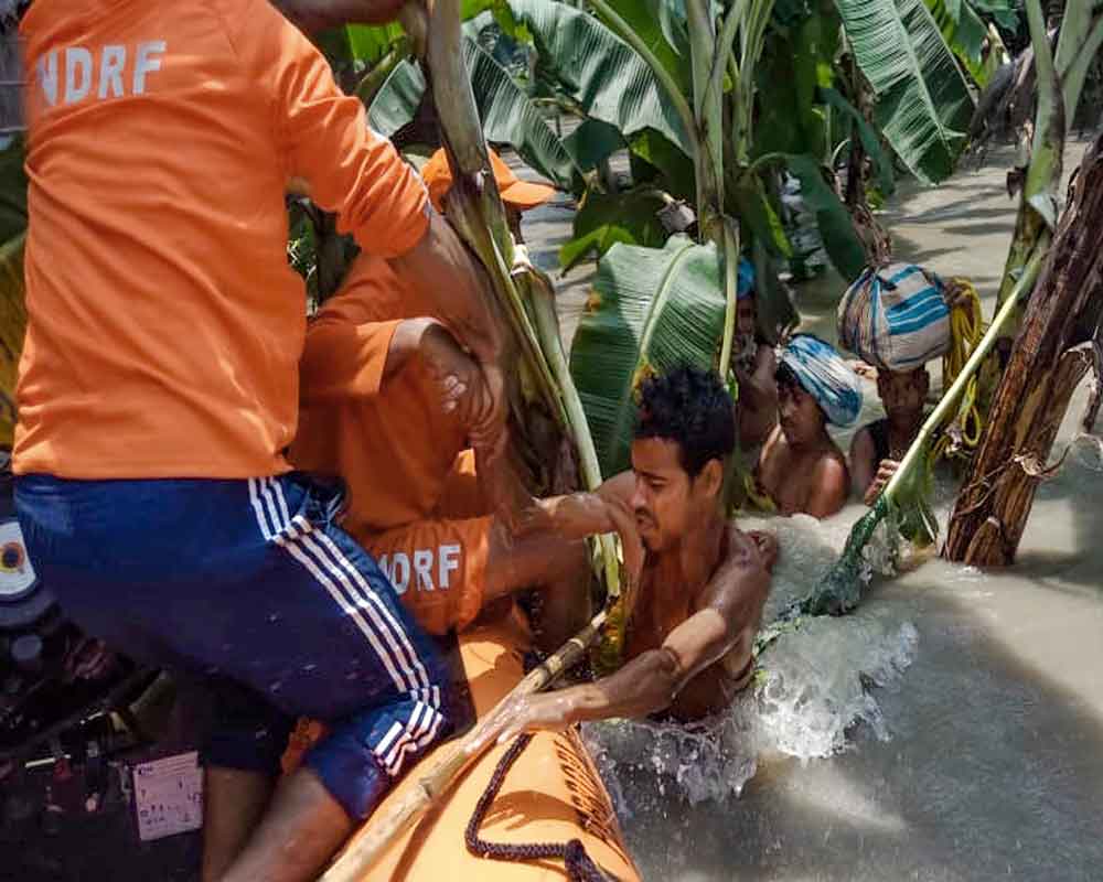 Morigaon: NDRF personnel rescue a person from a flood affected area, in Morigaon district. - PTI