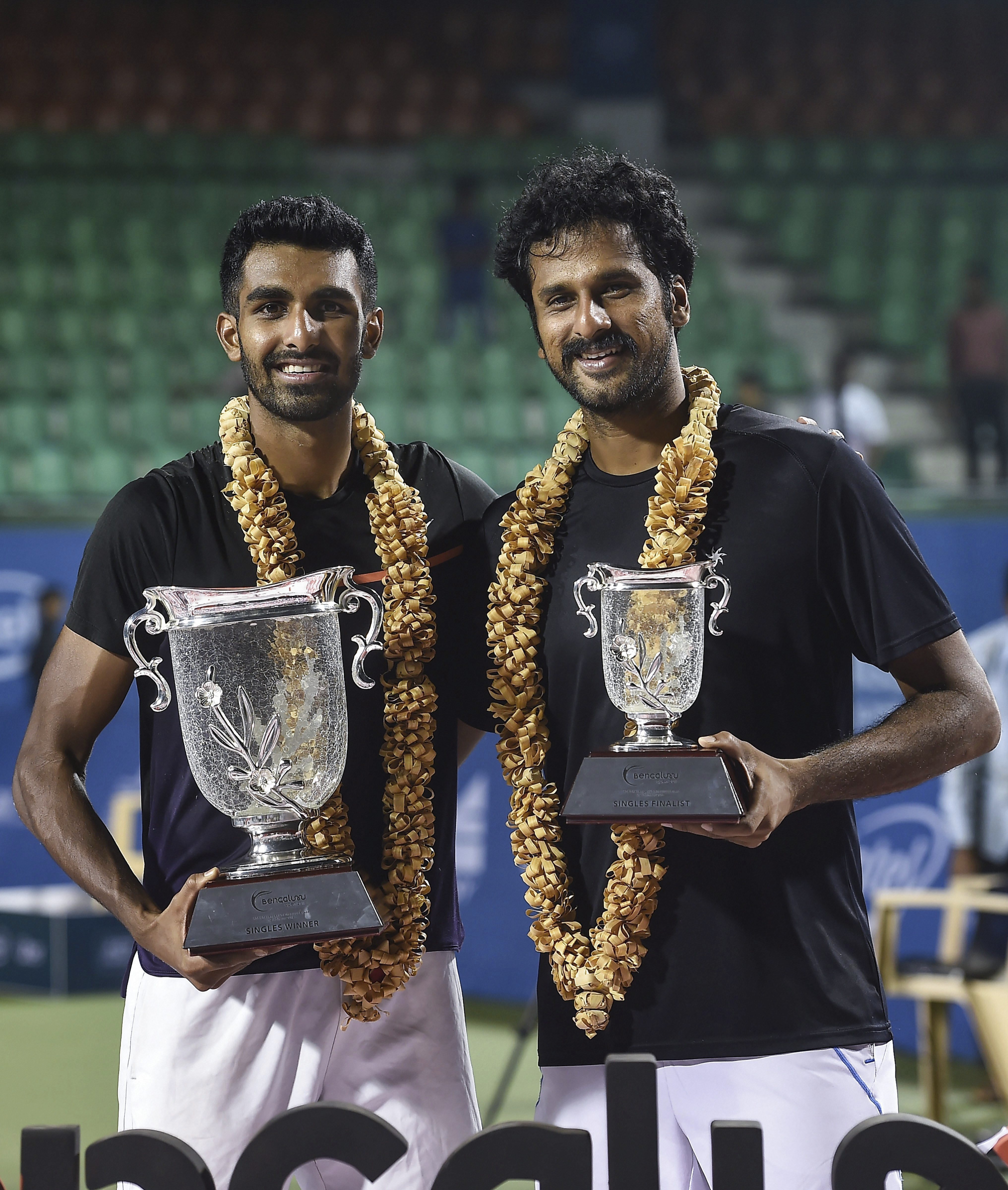 Winner Prajnesh Gunneswaran and runner up Saket Myneni pose with the trophies during the award presentation ceremony of the Final match of Bengaluru Tennis Open 2018 (ATP Challenger Tour) at Karnataka State Lawn Tennis Association in Bengaluru - PTI