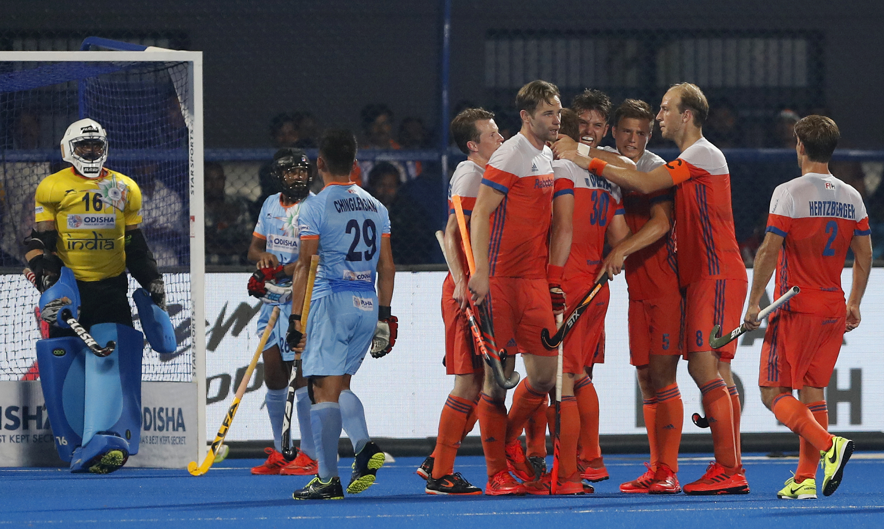 Netherlands players, in orange, celebrate after scoring a goal during the Men's Hockey World Cup quarterfinal match between India and Netherlands at Kalinga Stadium in Bhubaneswar - AP
