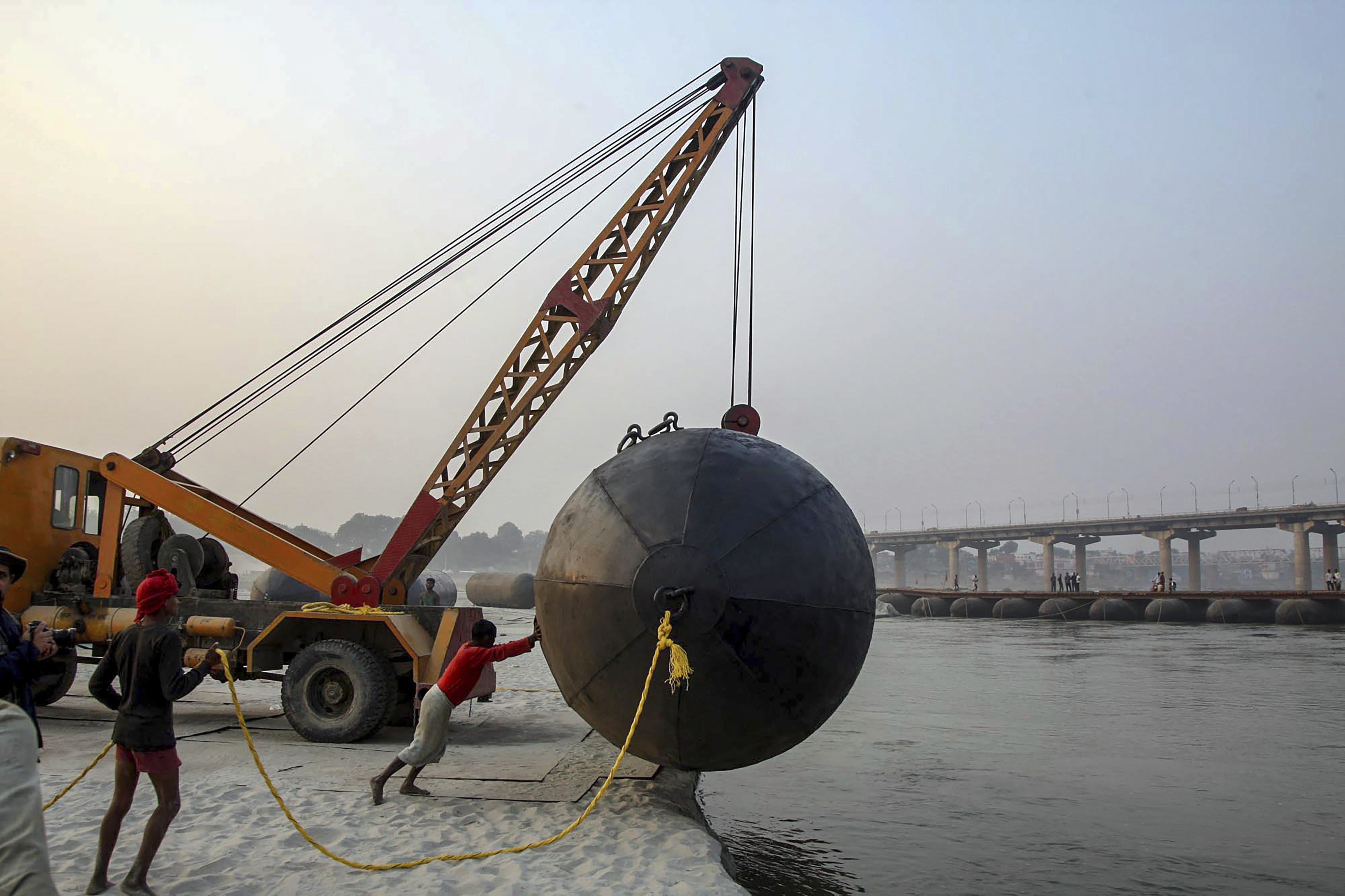 Workers construct a pontoon bridge over River Ganga for upcoming Kumbh Mela 2019, in Allahabad - PTI