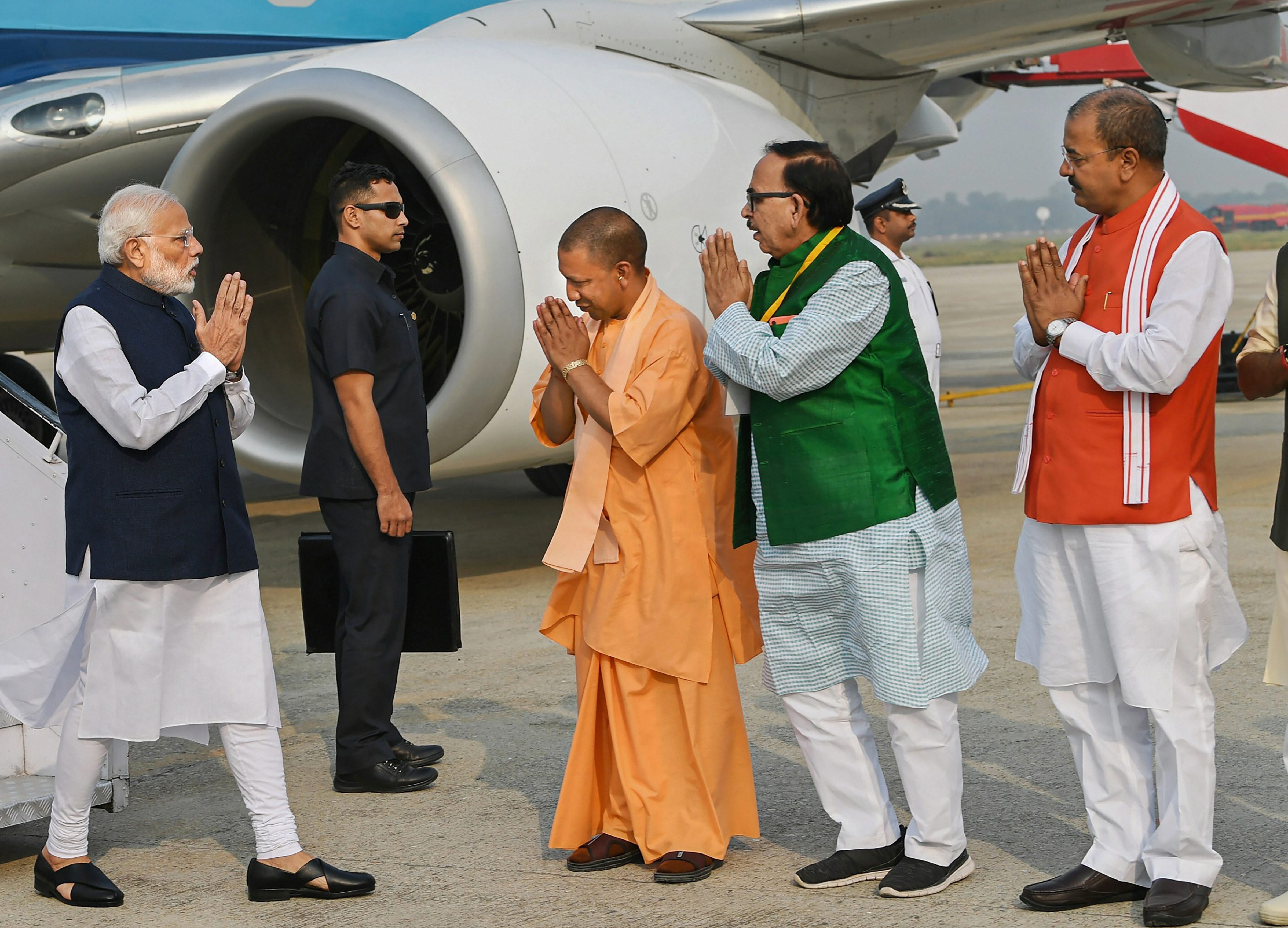 Prime Minister Narendra Modi being received by Uttar Pradesh Chief Minister Yogi Adityanath, UP BJP chief Mahendra Nath Pandey and UP Deputy Chief Minister Keshav Prasad Maurya on his arrival, in Varanasi - PTI