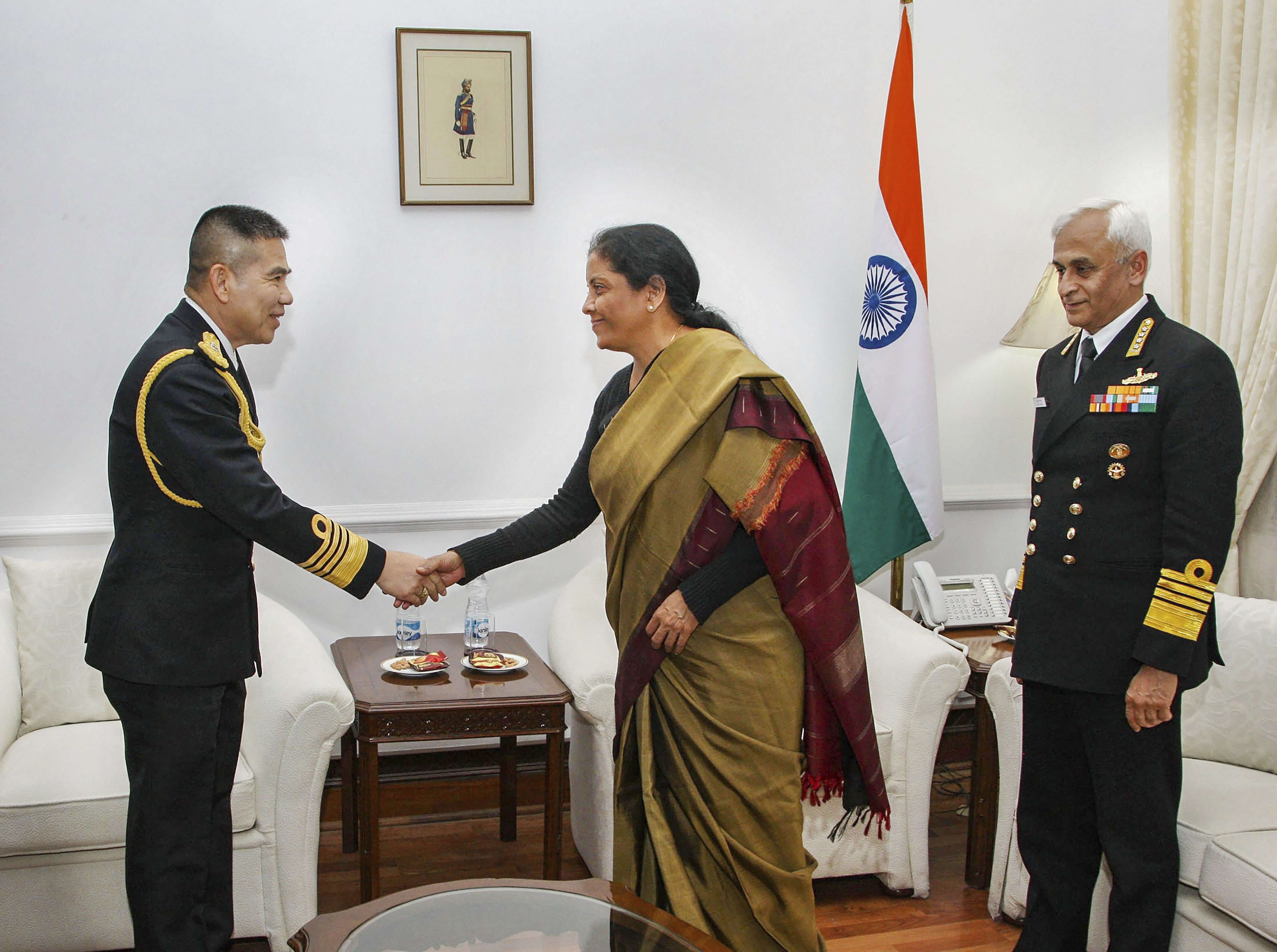 Union Defence Minister Nirmala Sitharaman shakes hands with Royal Thai Navy Commander-in-Chief Adm Luechai Ruddit during a call-on as Chief of Naval Staff Admiral Sunil Lanba looks on, in New Delhi - PTI