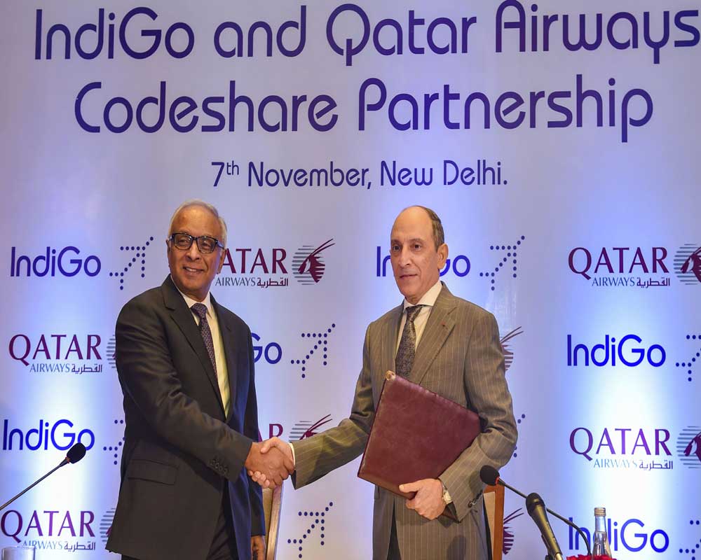 IndiGo CEO Ronojoy Dutta shakes hands with Qatar Airways' CEO Akbar Al Bake during a business announcement of a strategic code-share partnership between Indigo and Qatar airways, in New Delhi - PTI