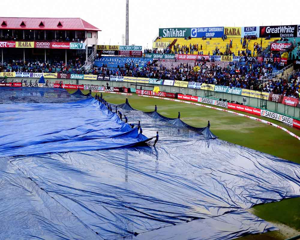 Stadium ground staff clear the ground  at the Himachal Pradesh Cricket Association (HPCA) ahead of the first T20 match between India and South Africa, in Dharamshala - PTI